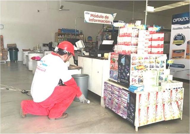 Un hombre arrodillado frente a un cartel que dice módulo de información