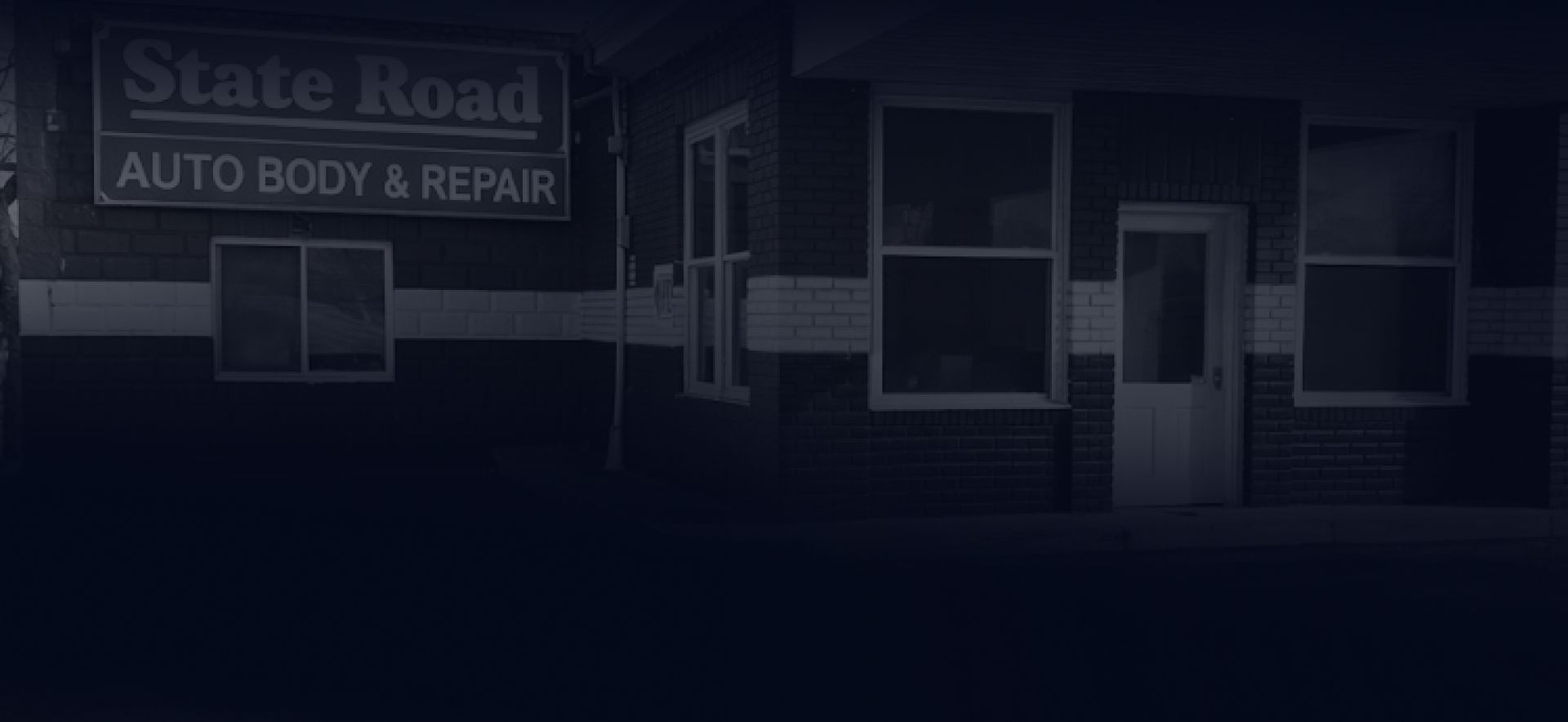 Dark, dimly lit exterior of a brick 