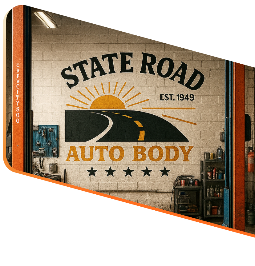 A mural on a white brick wall inside an auto body shop reading