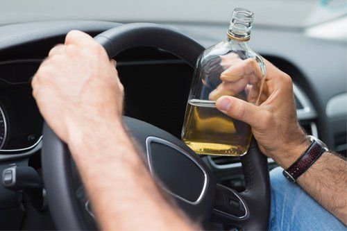 Man Drinking While Driving