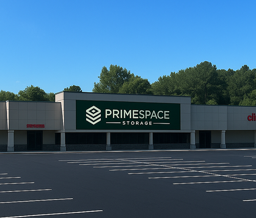 A large green sign on the side of a building that says primespace storage.