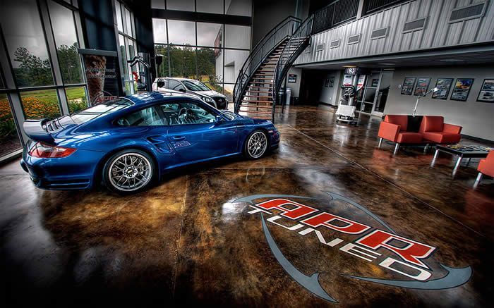 A blue sports car is parked in a showroom.