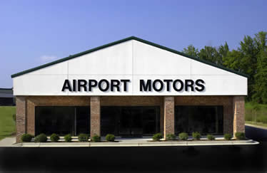 A white building with the words airport motors on it