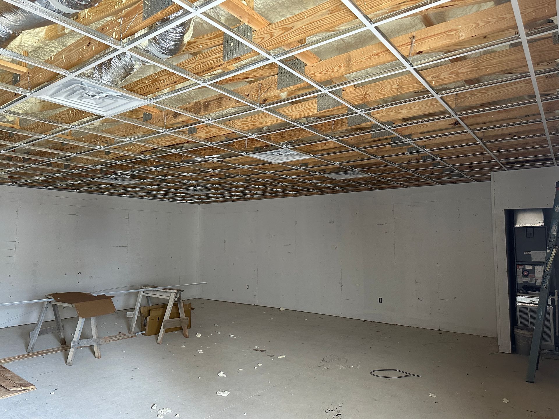 An empty room with a ceiling that is being remodeled.