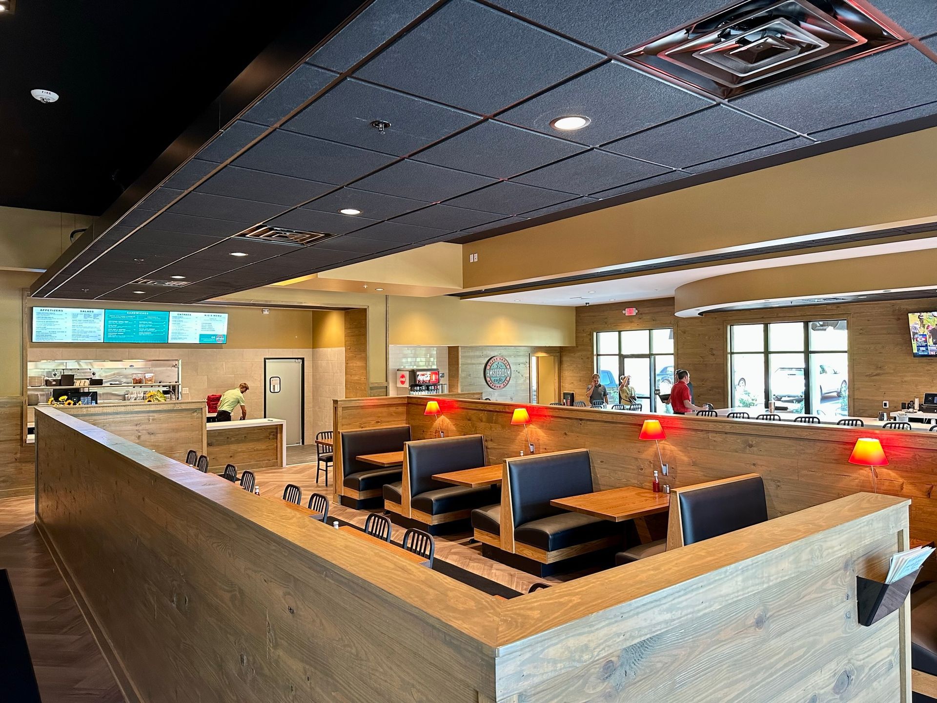 The inside of a restaurant with tables and chairs.