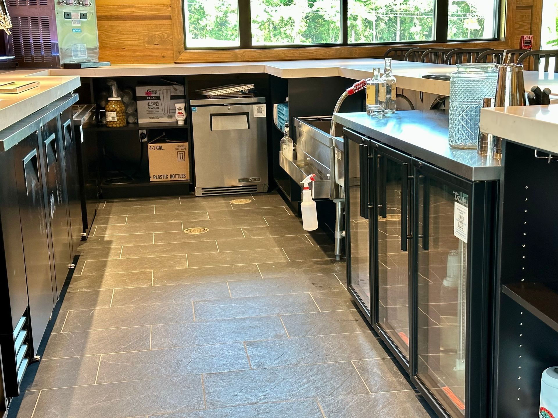 A kitchen with stainless steel appliances and a glass door refrigerator.