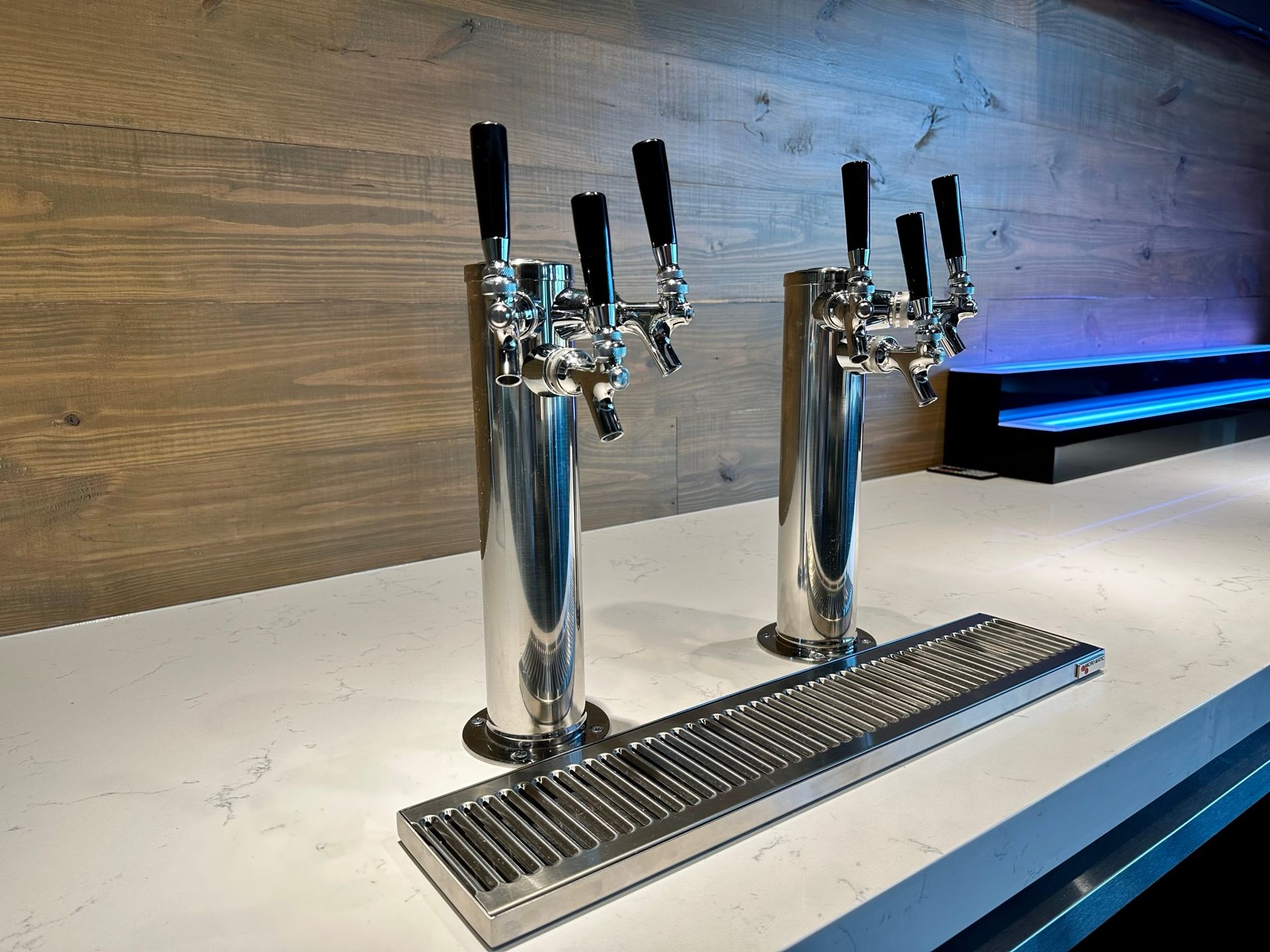 Two beer taps are sitting on top of a counter.