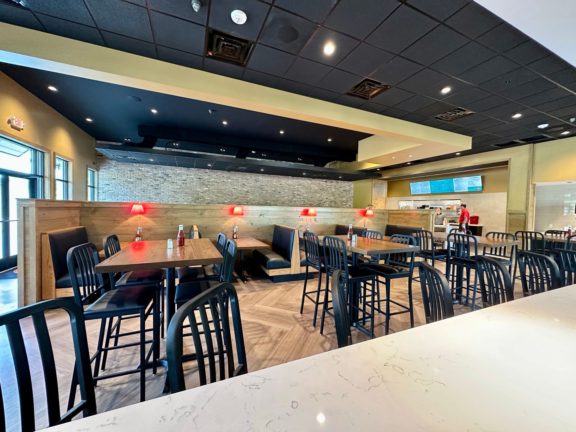 A restaurant with tables and chairs in a large room.