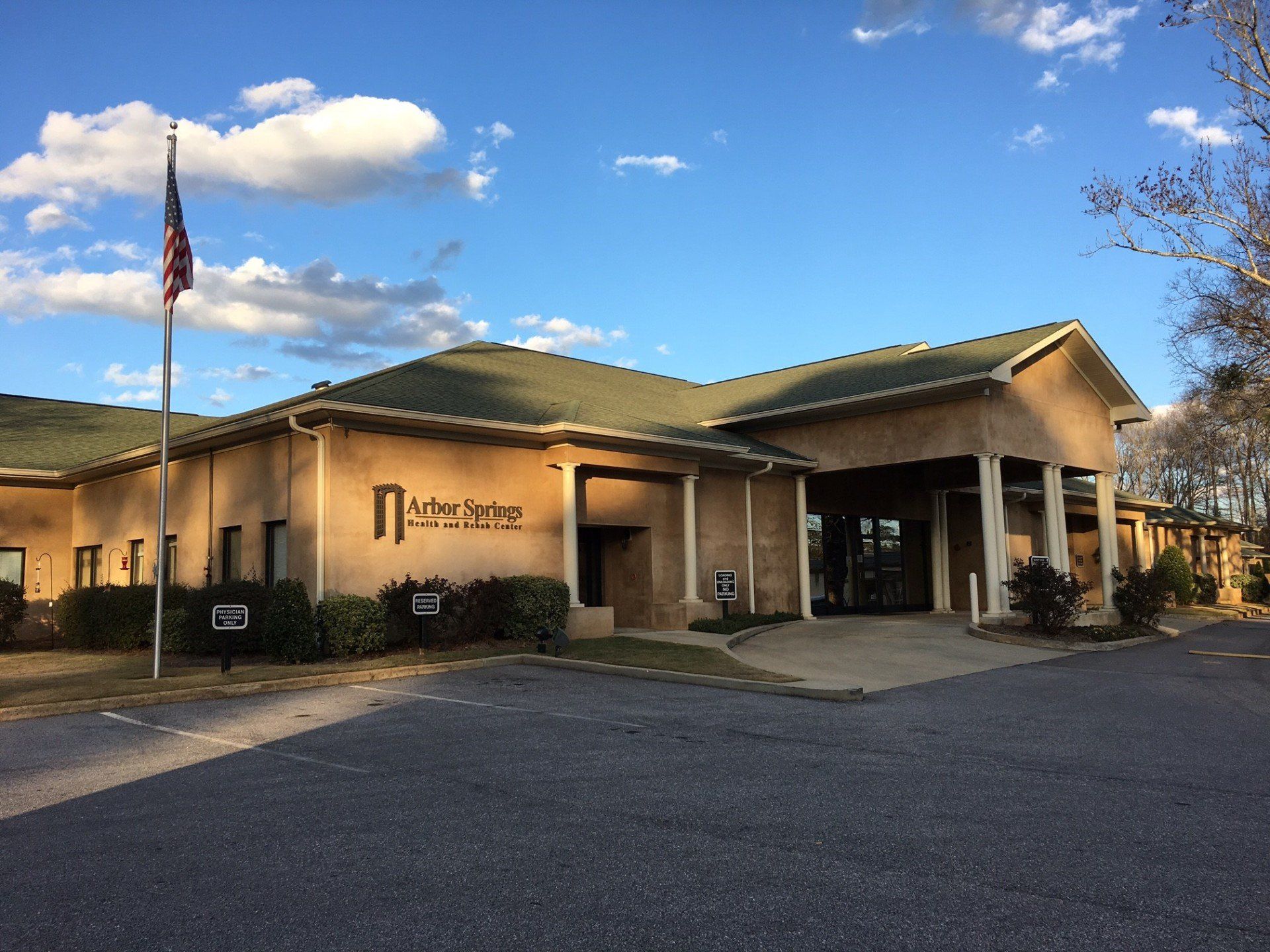 A large building with a green roof and a flag in front of it