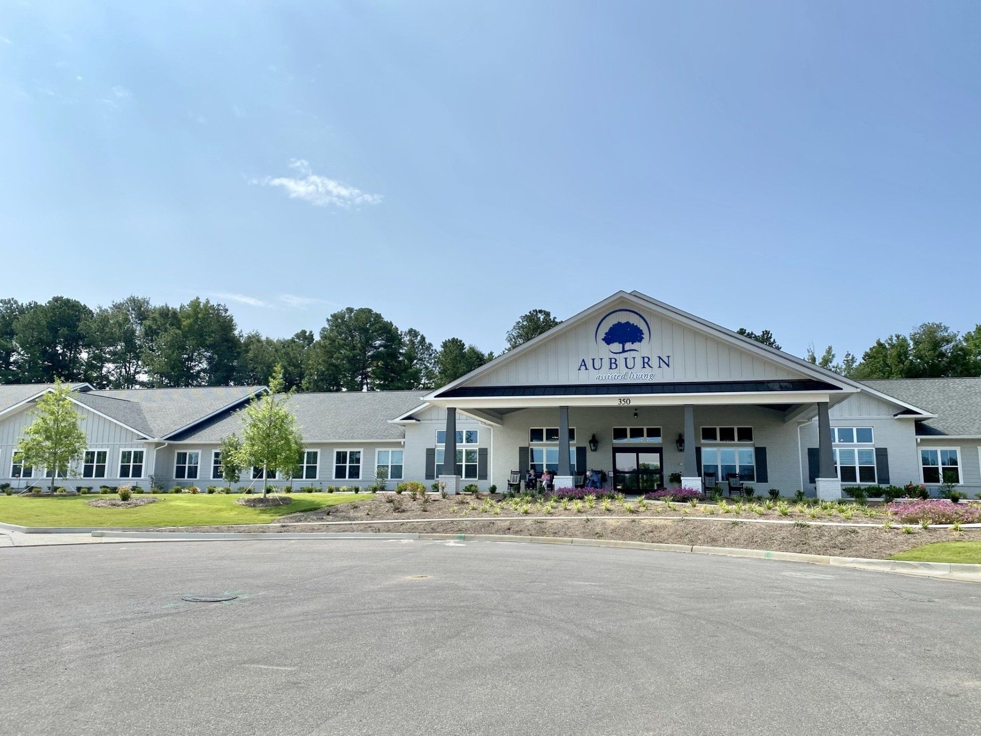 A large white building with a tree on the front of it.