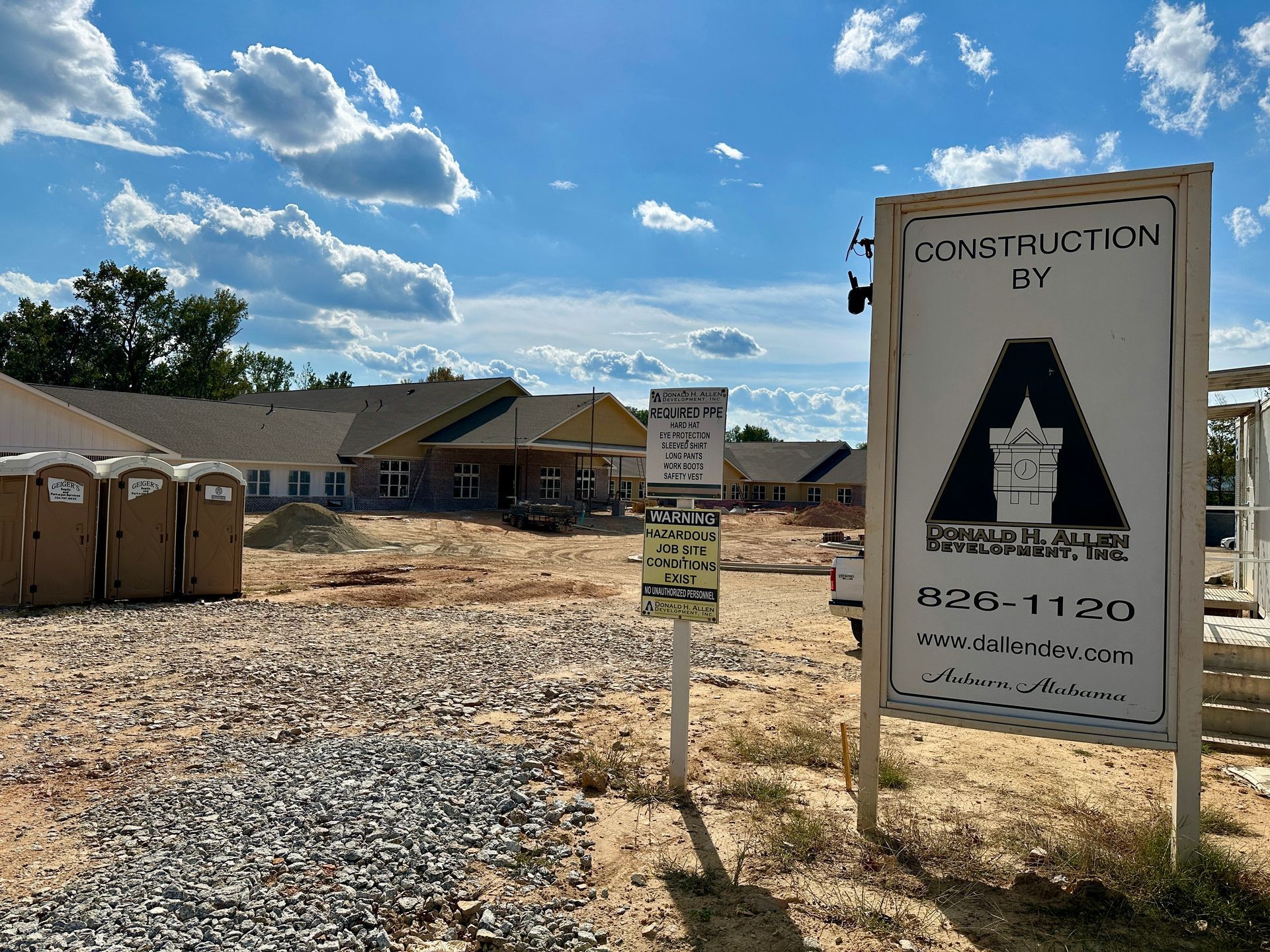 Construction site with buildings under development; sign reads 