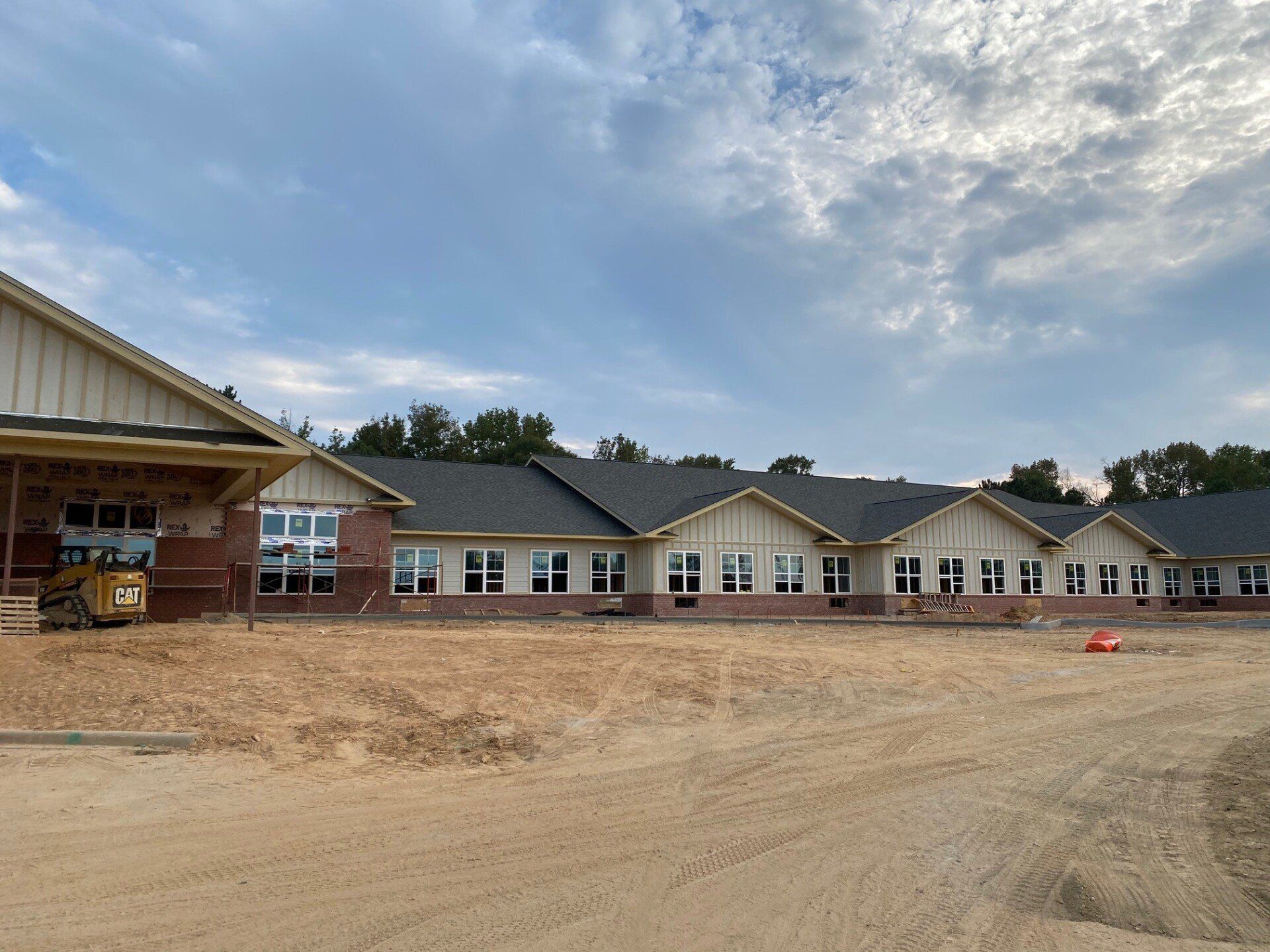 A large building with a lot of windows is under construction.