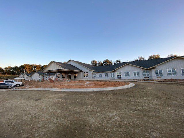 A large white commercial structure with a lot of windows is being built.