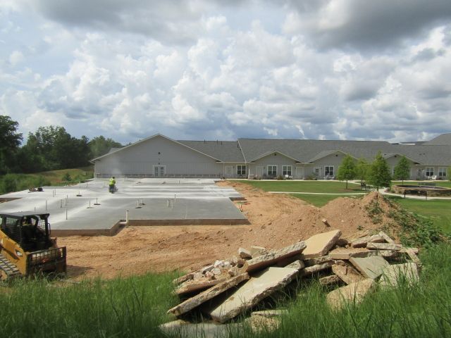A construction site with a large building in the background