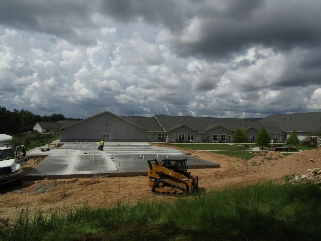 A construction site with a large building in the background