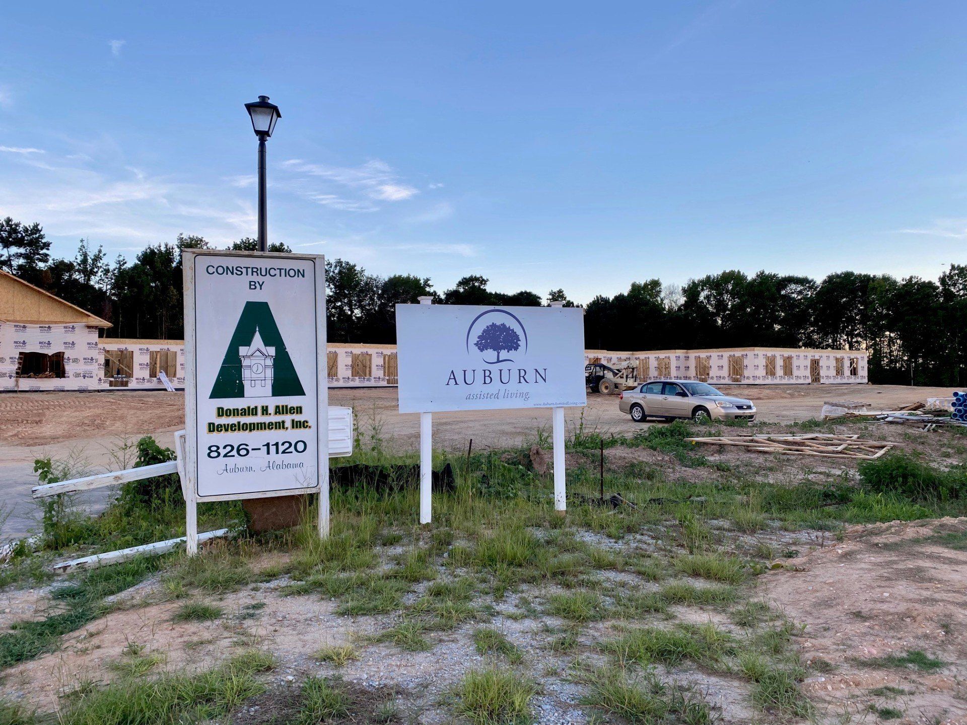 Two signs are sitting in the middle of a grassy field.