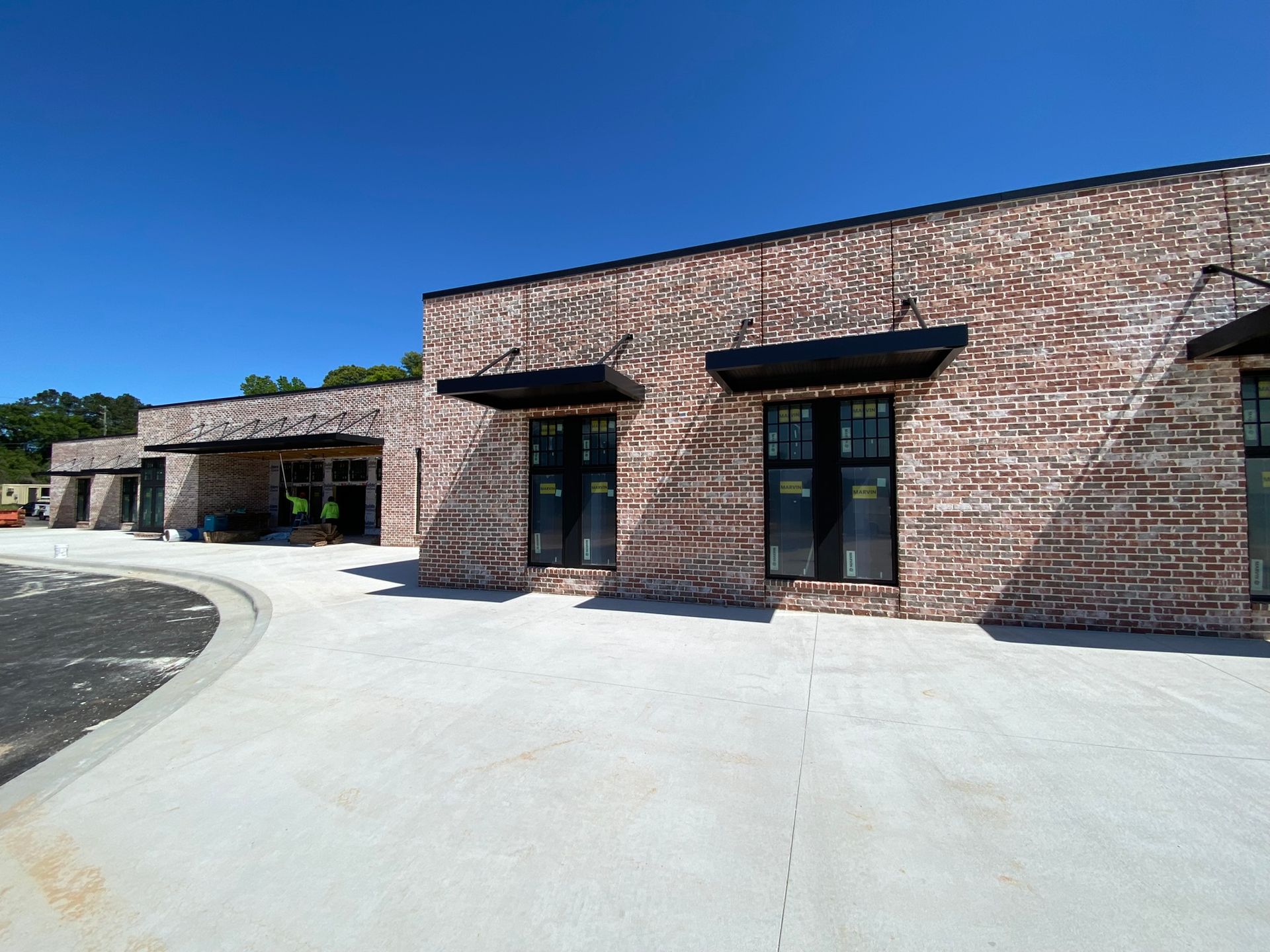 A large brick building with a lot of windows on a sunny day.