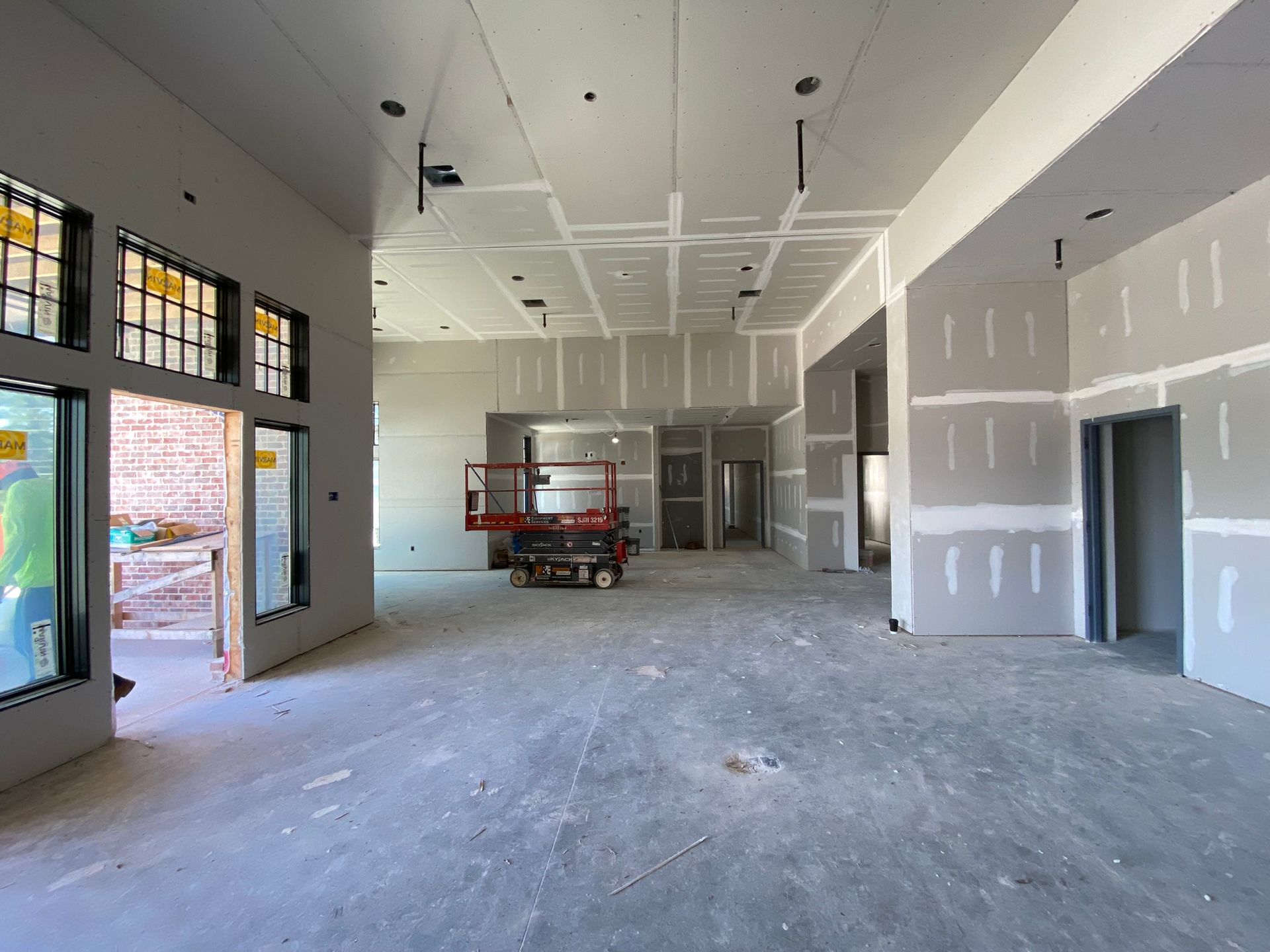 A large empty room with drywall on the walls and ceiling.