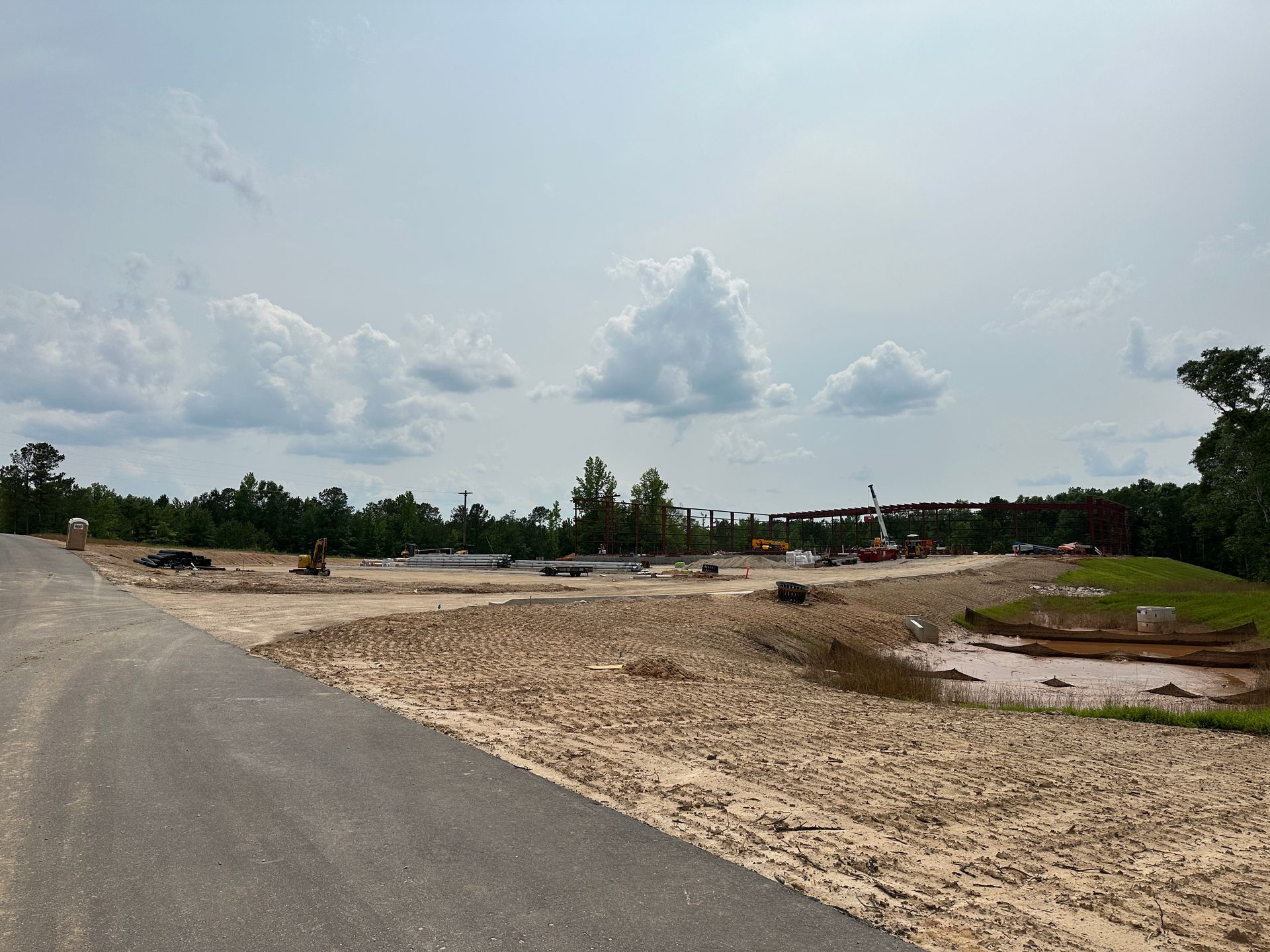 A dirt road going through a construction site