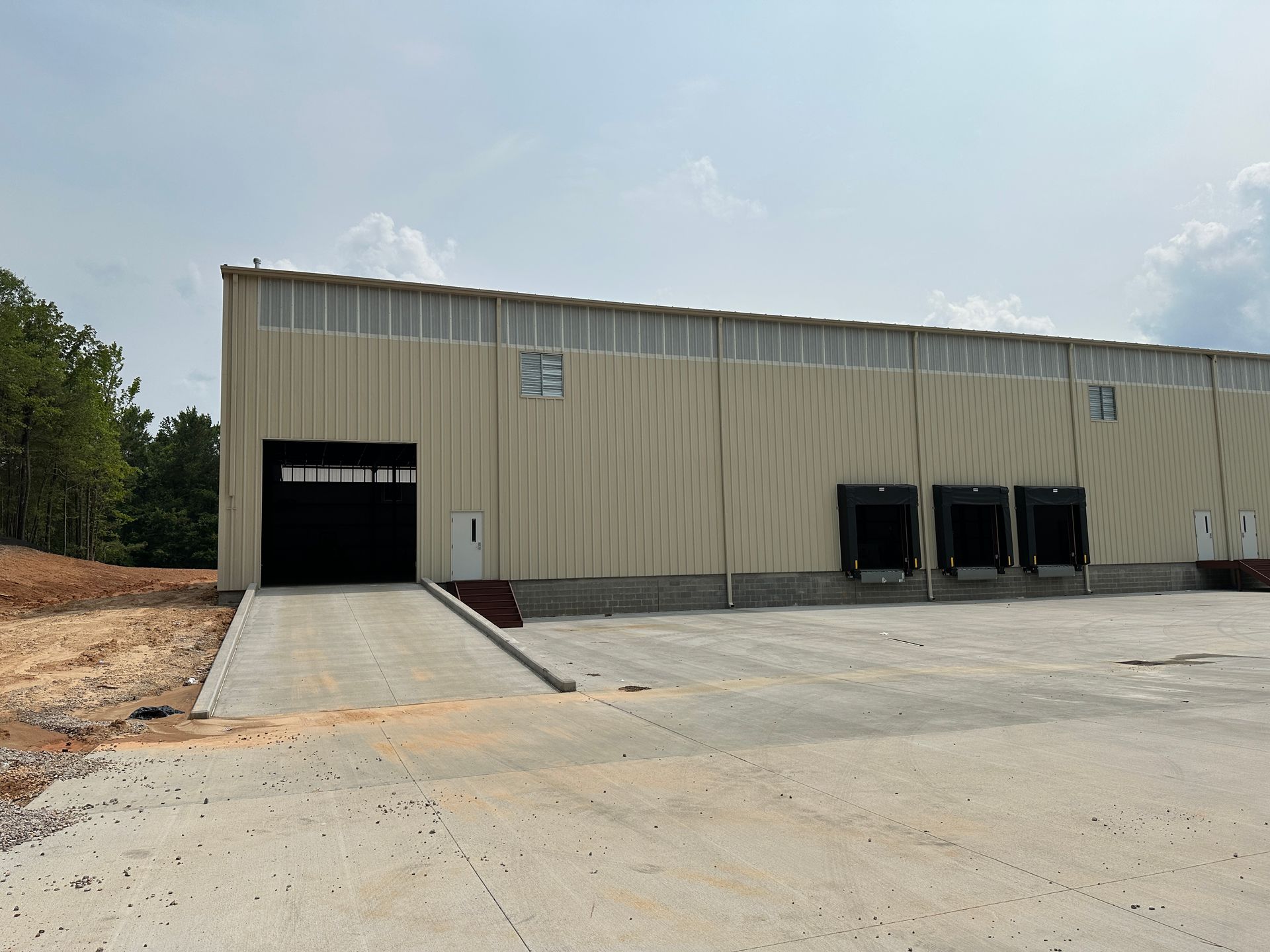 A large warehouse with a ramp leading to it