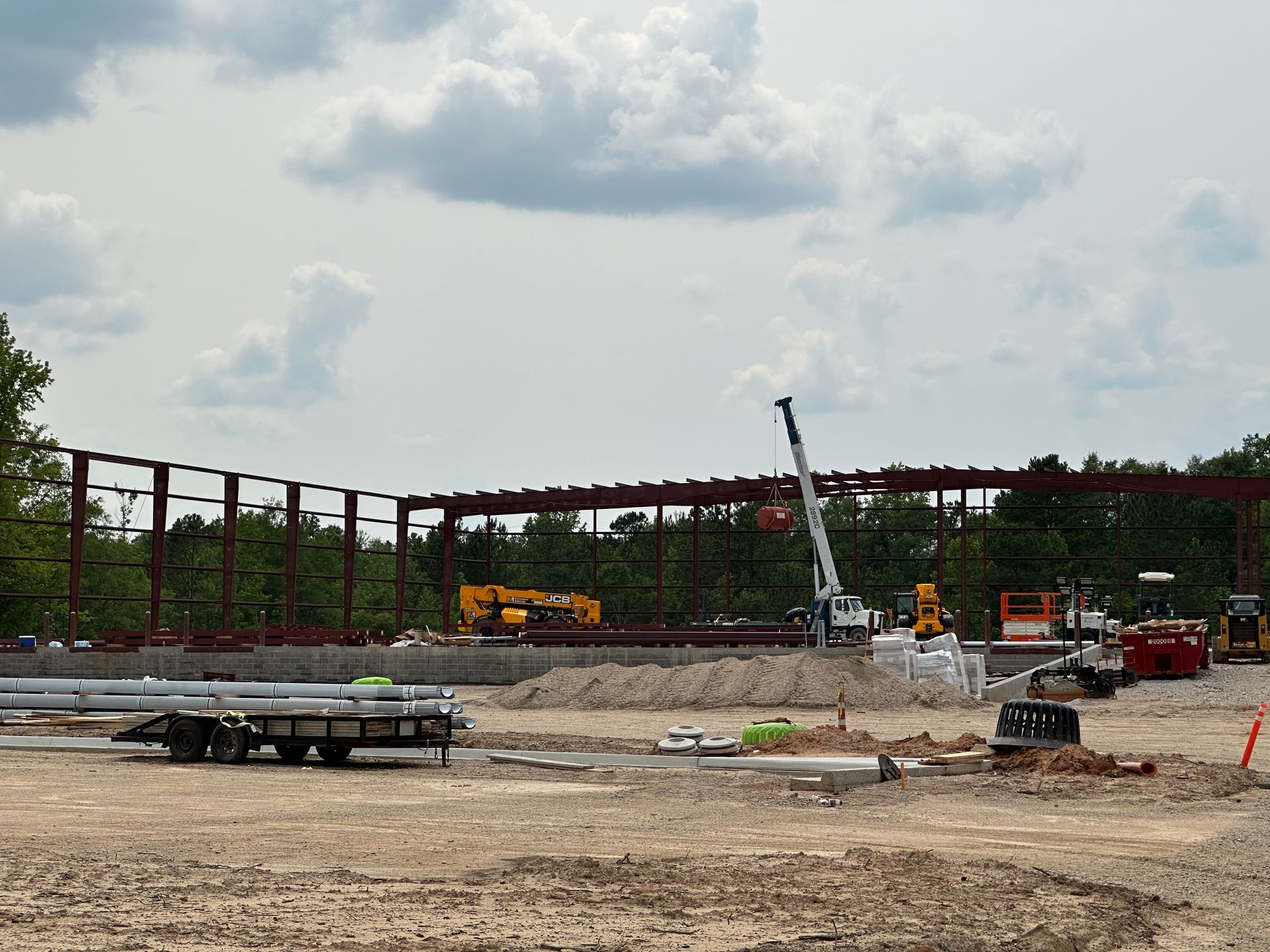 A construction site with a large metal structure in the background