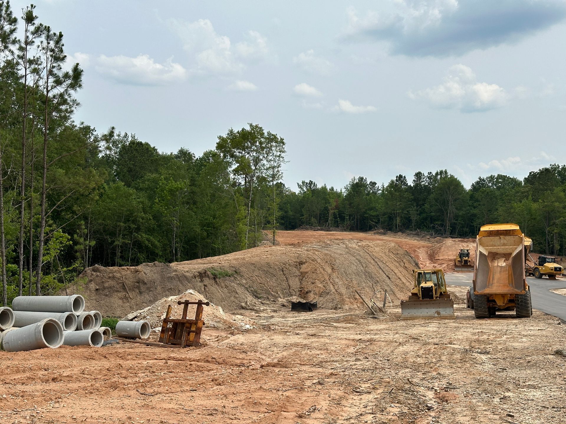 A construction site with a bulldozer and a dump truck