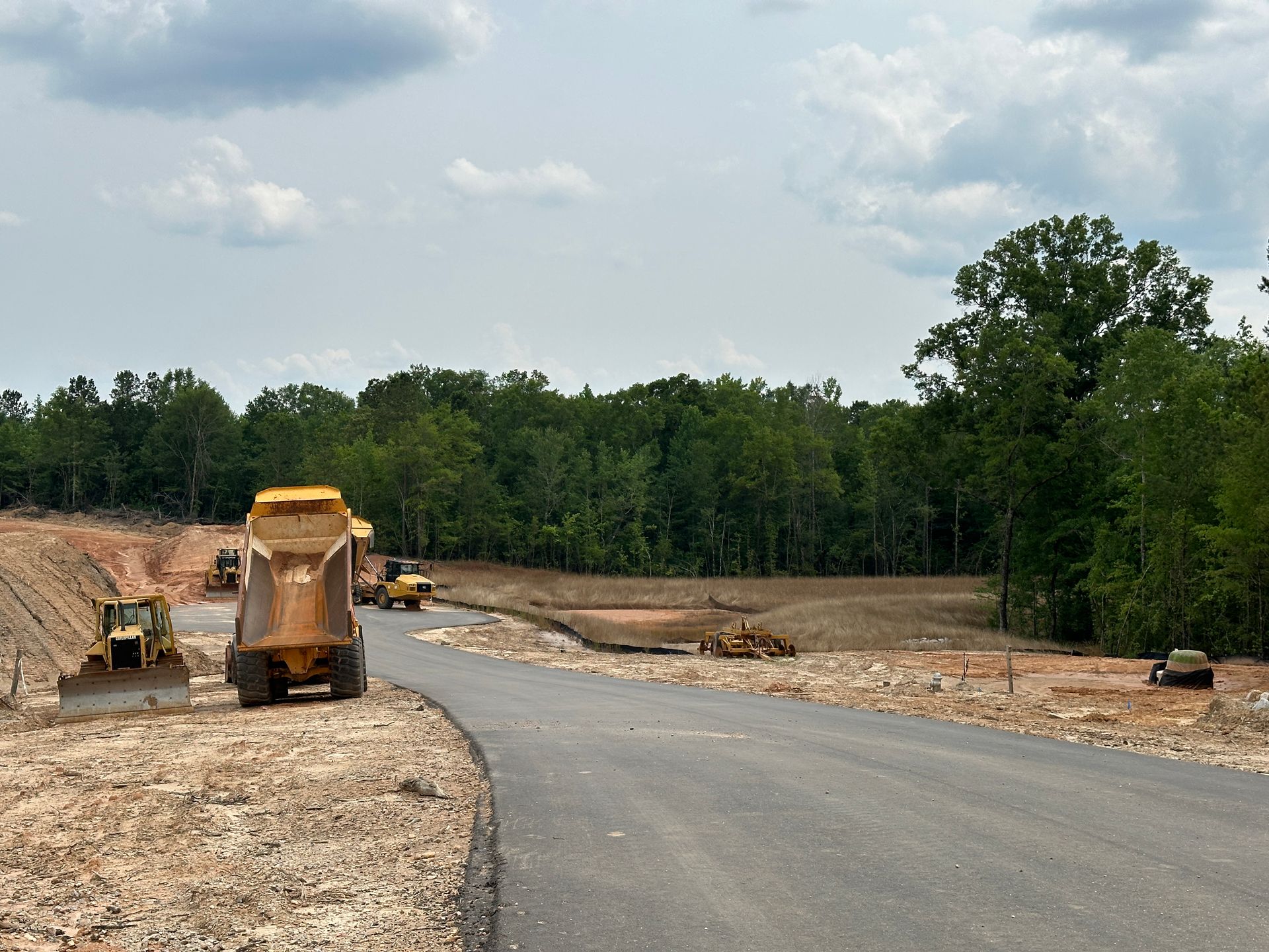 A dump truck is parked on the side of a road.