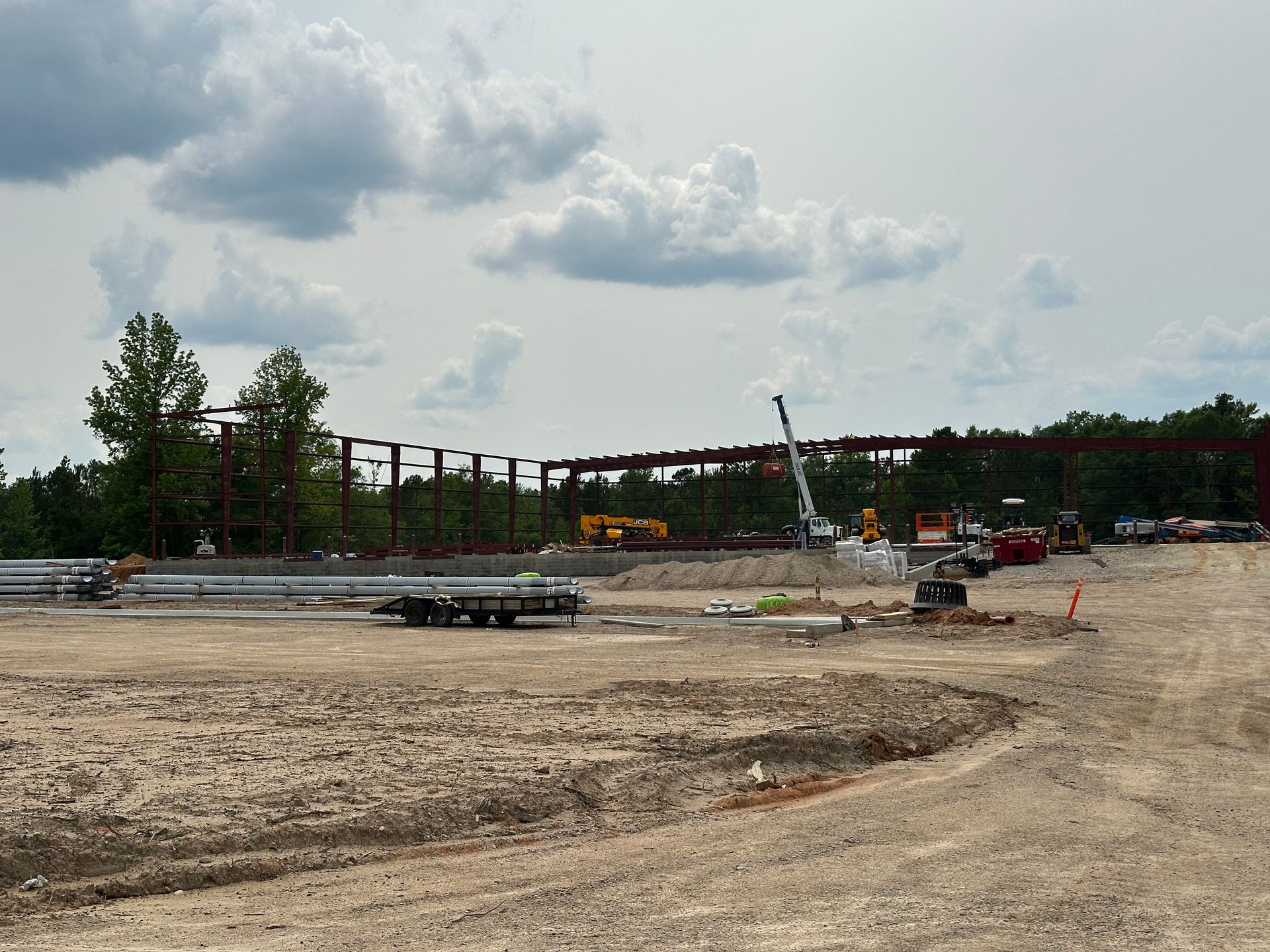 A large construction site with a crane in the background
