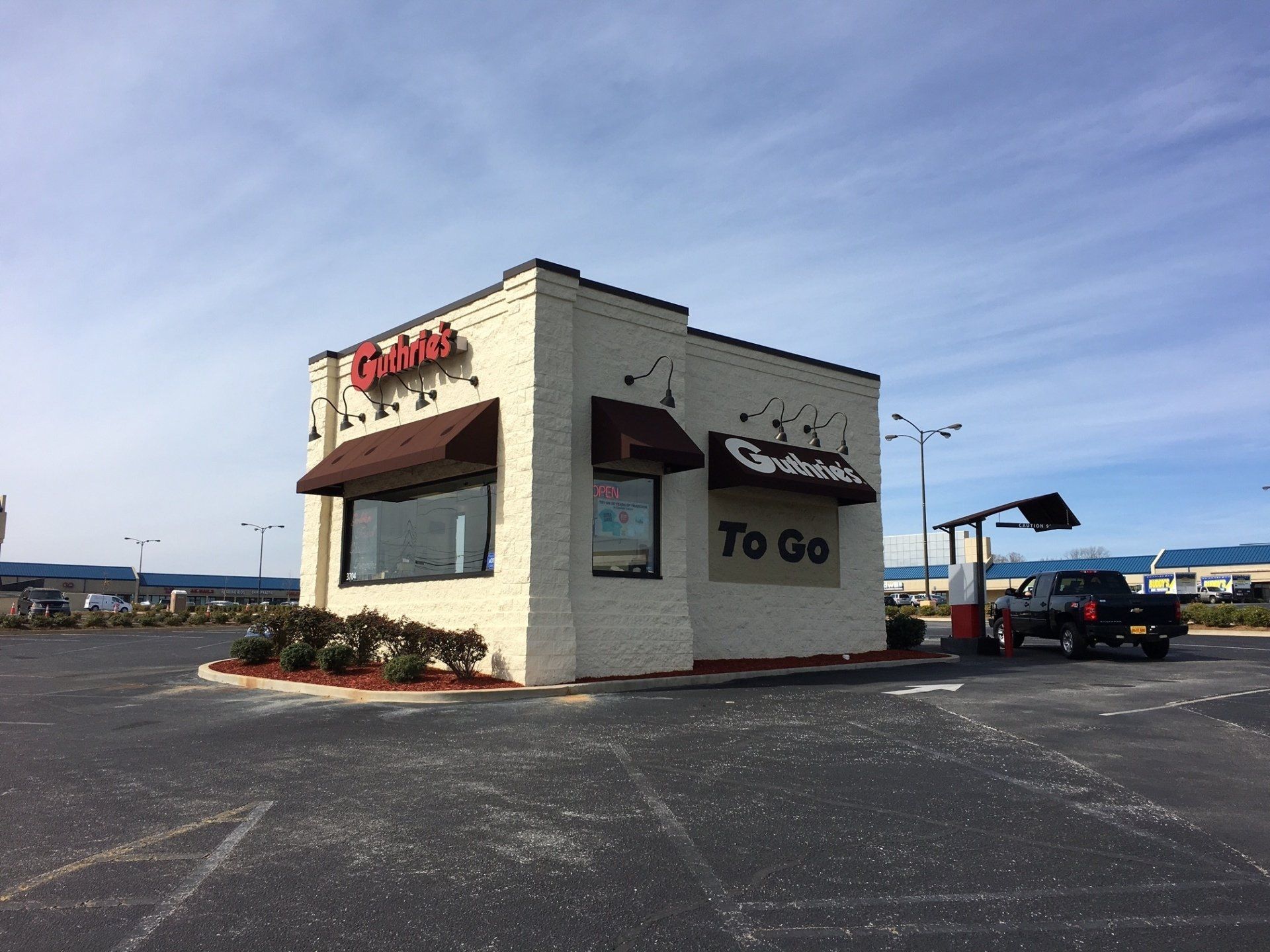 A white building with a sign that says to go