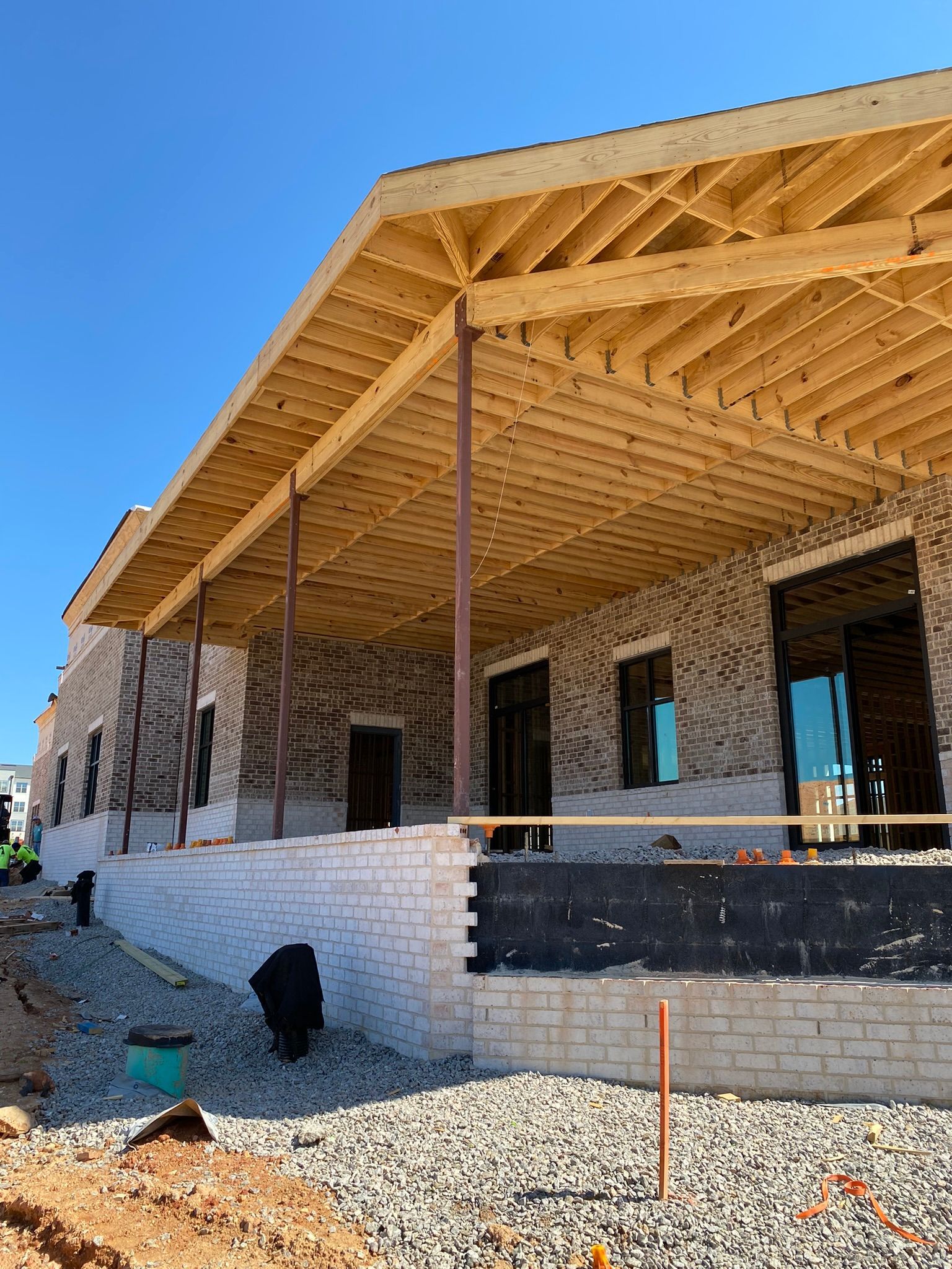 A large brick building under construction with a wooden roof.