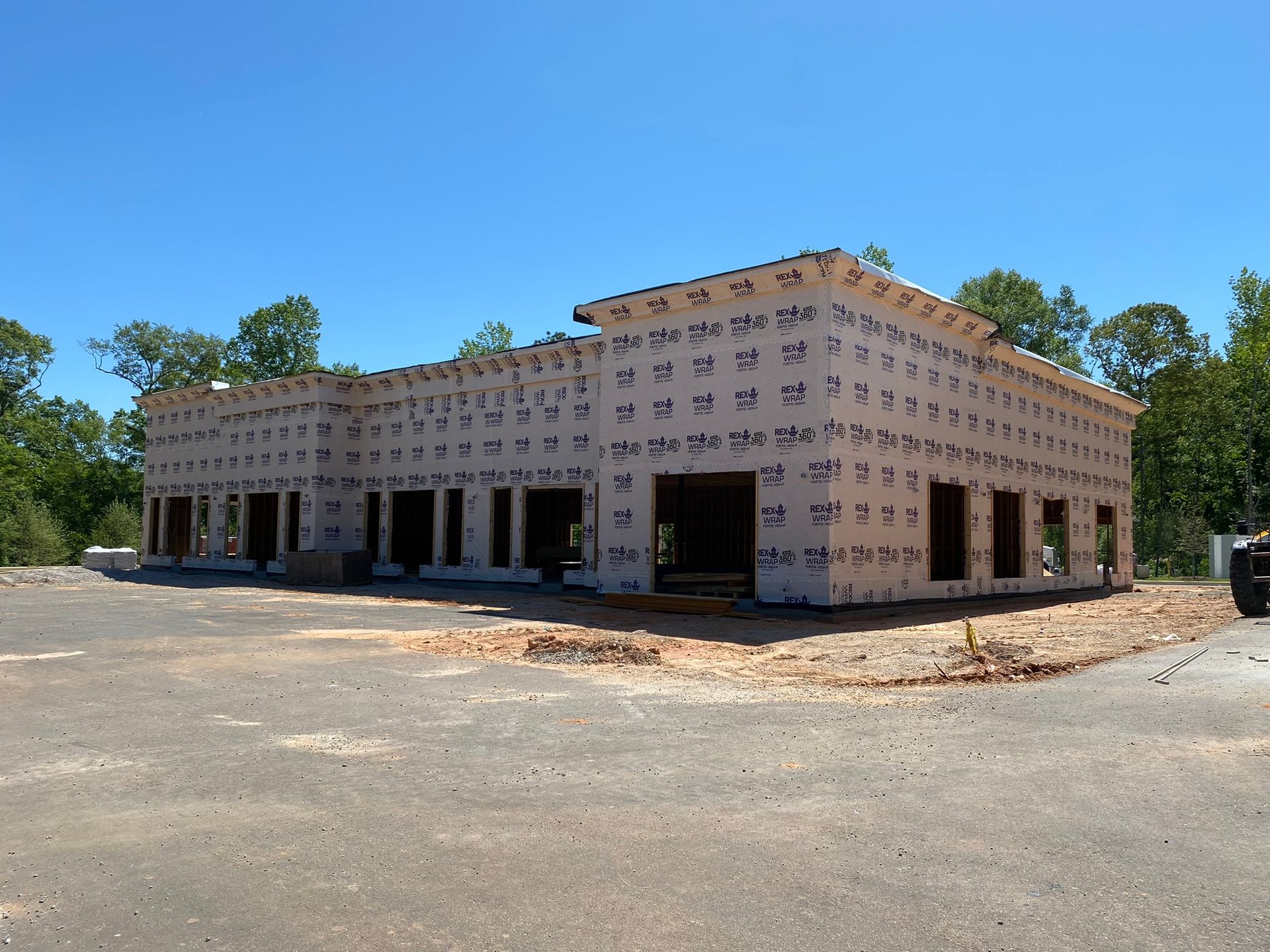 A building under construction with a blue sky in the background