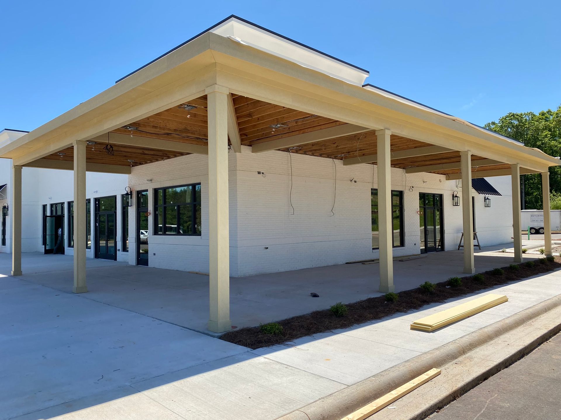 A white building with a covered walkway in front of it