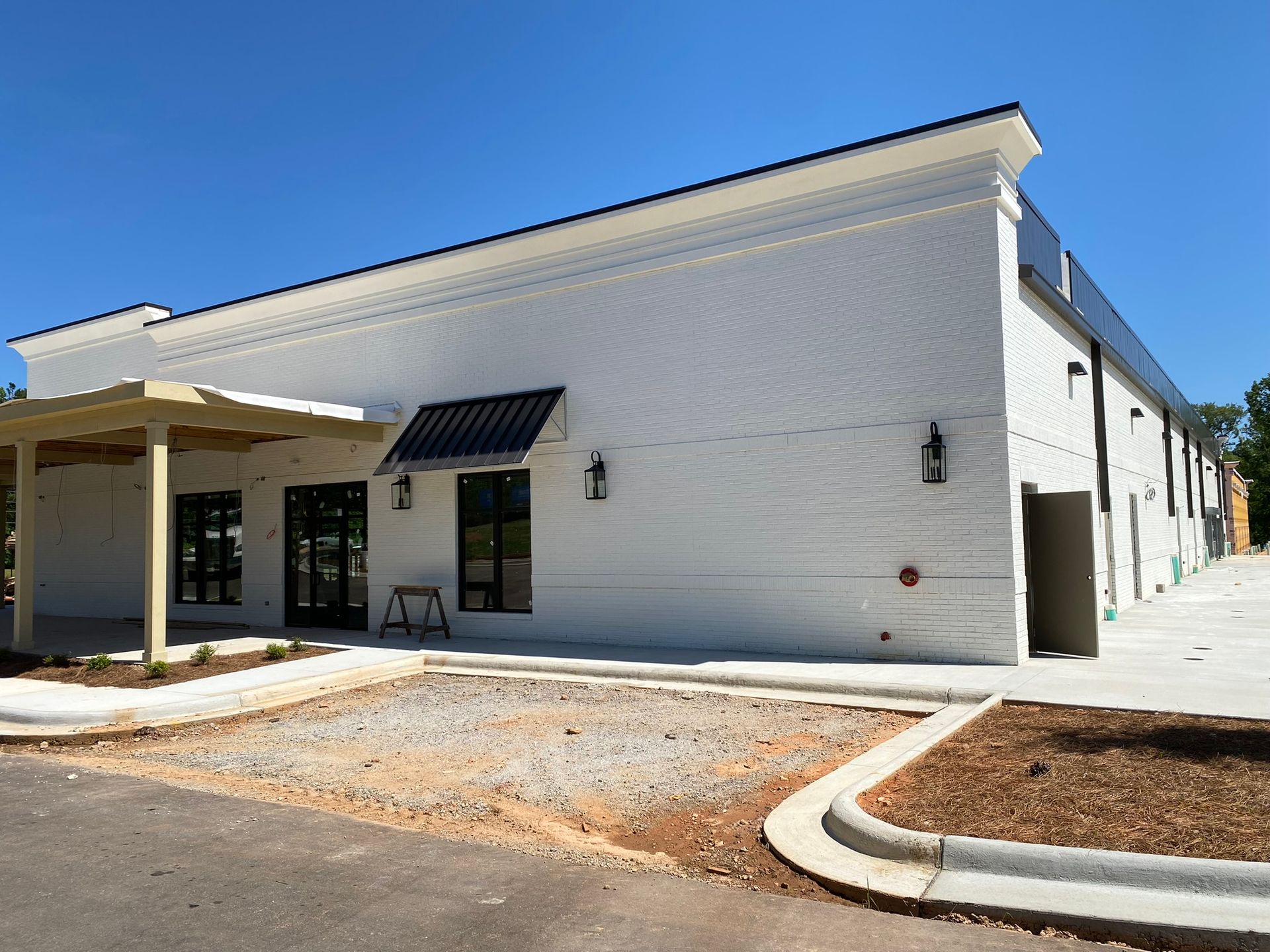 A large white building with a lot of windows is being built.