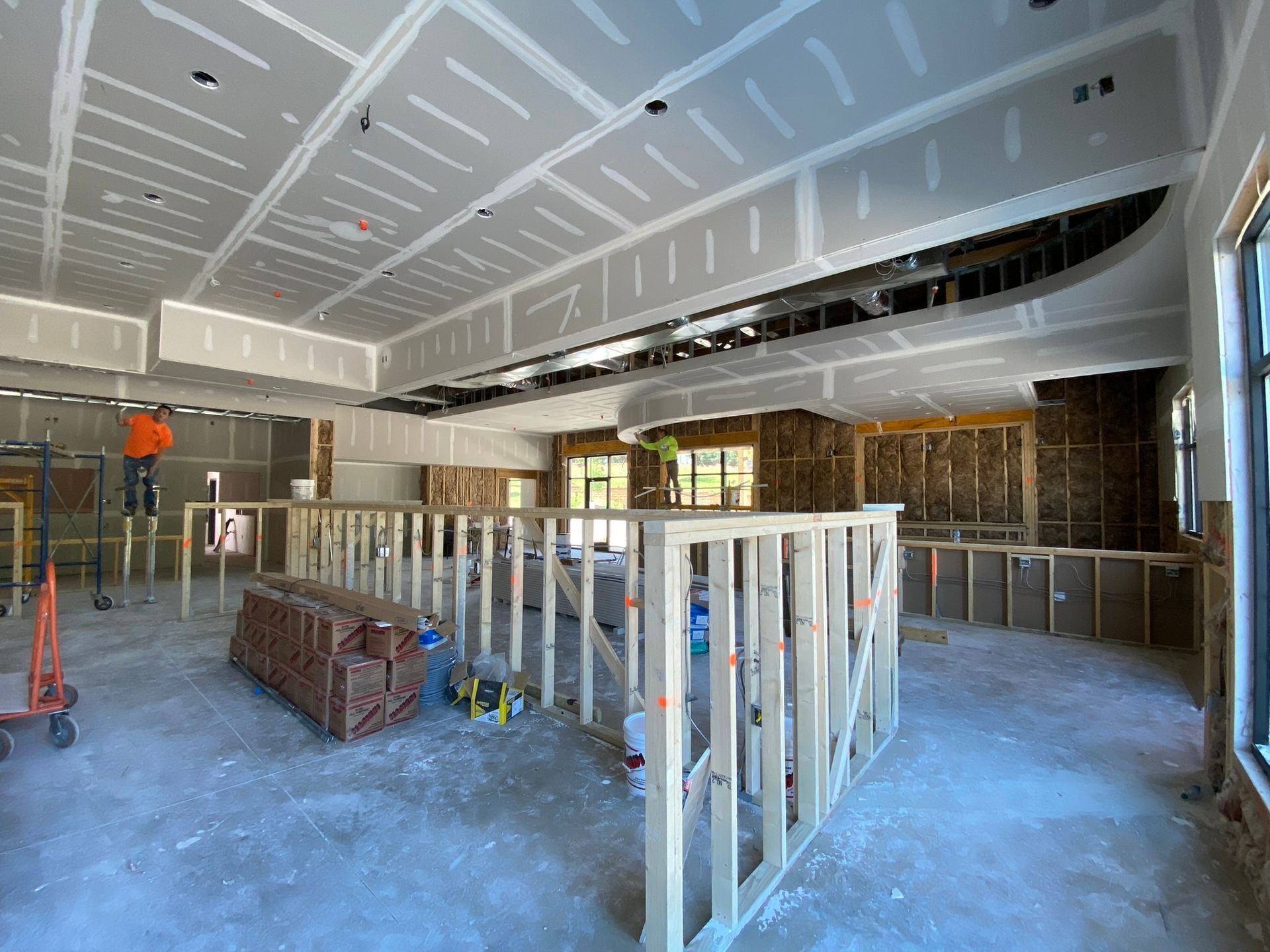 A large room with a ceiling that is being built.
