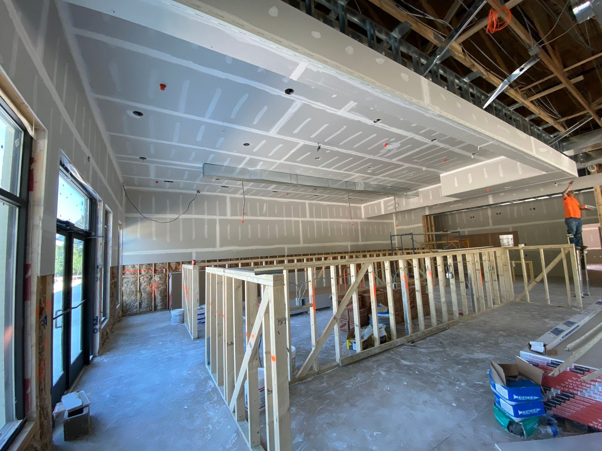 A large room with a ceiling that is being built.