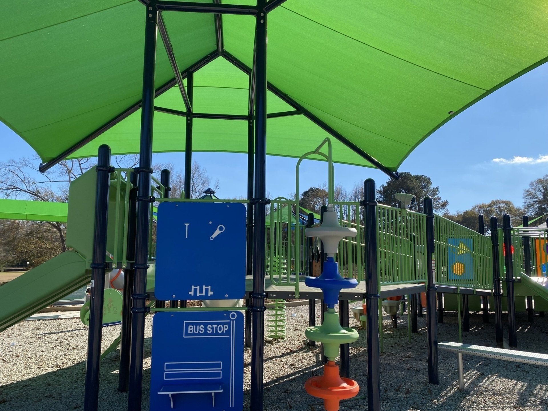 A playground with a blue box that says bus stop on it