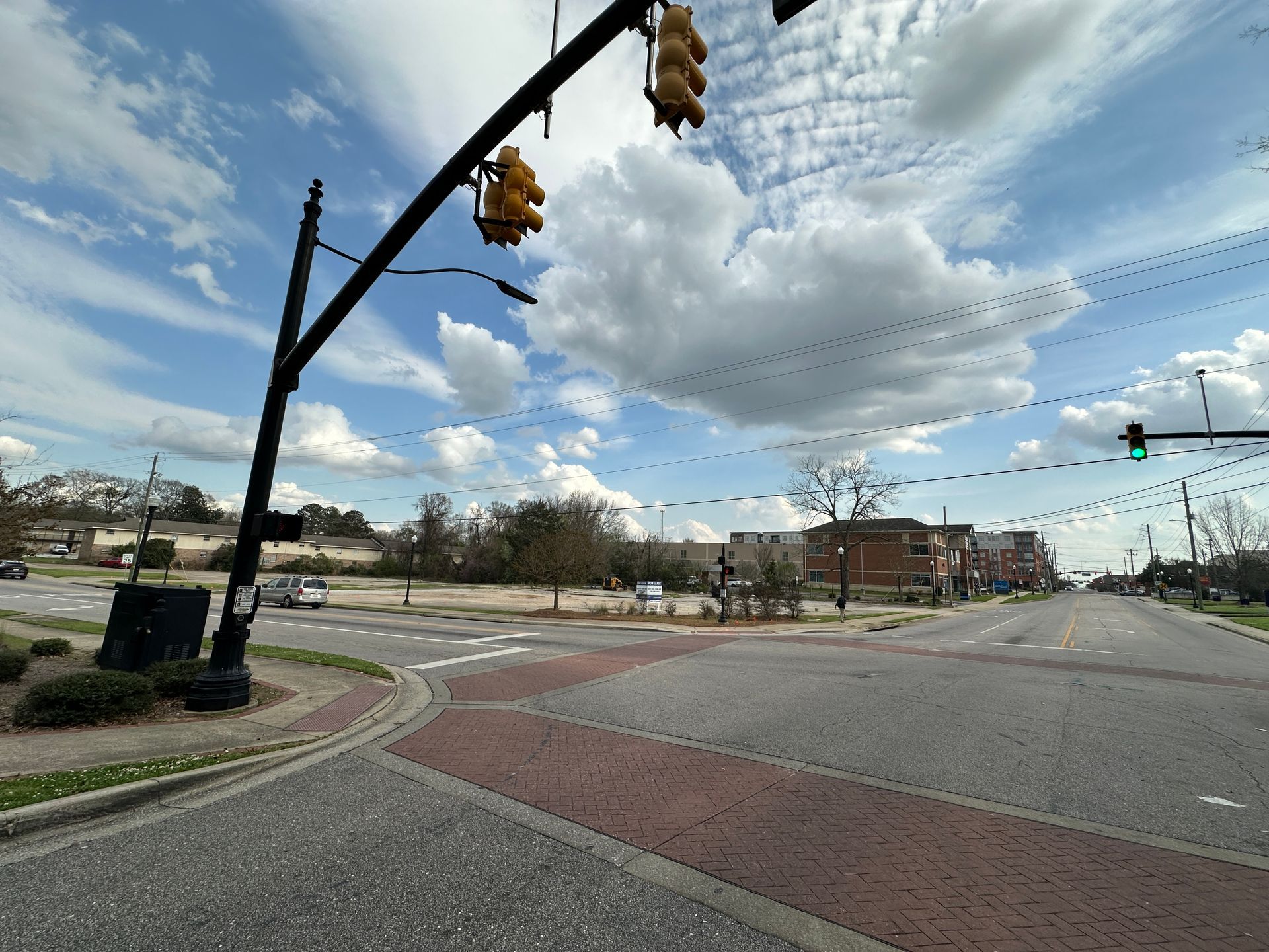 An aerial view of a new Hovey Precast office building with a blue roof surrounded by trees.