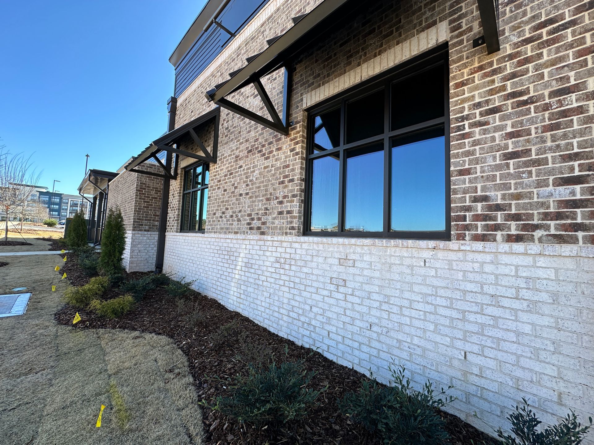 A brick building with a lot of windows and a canopy.