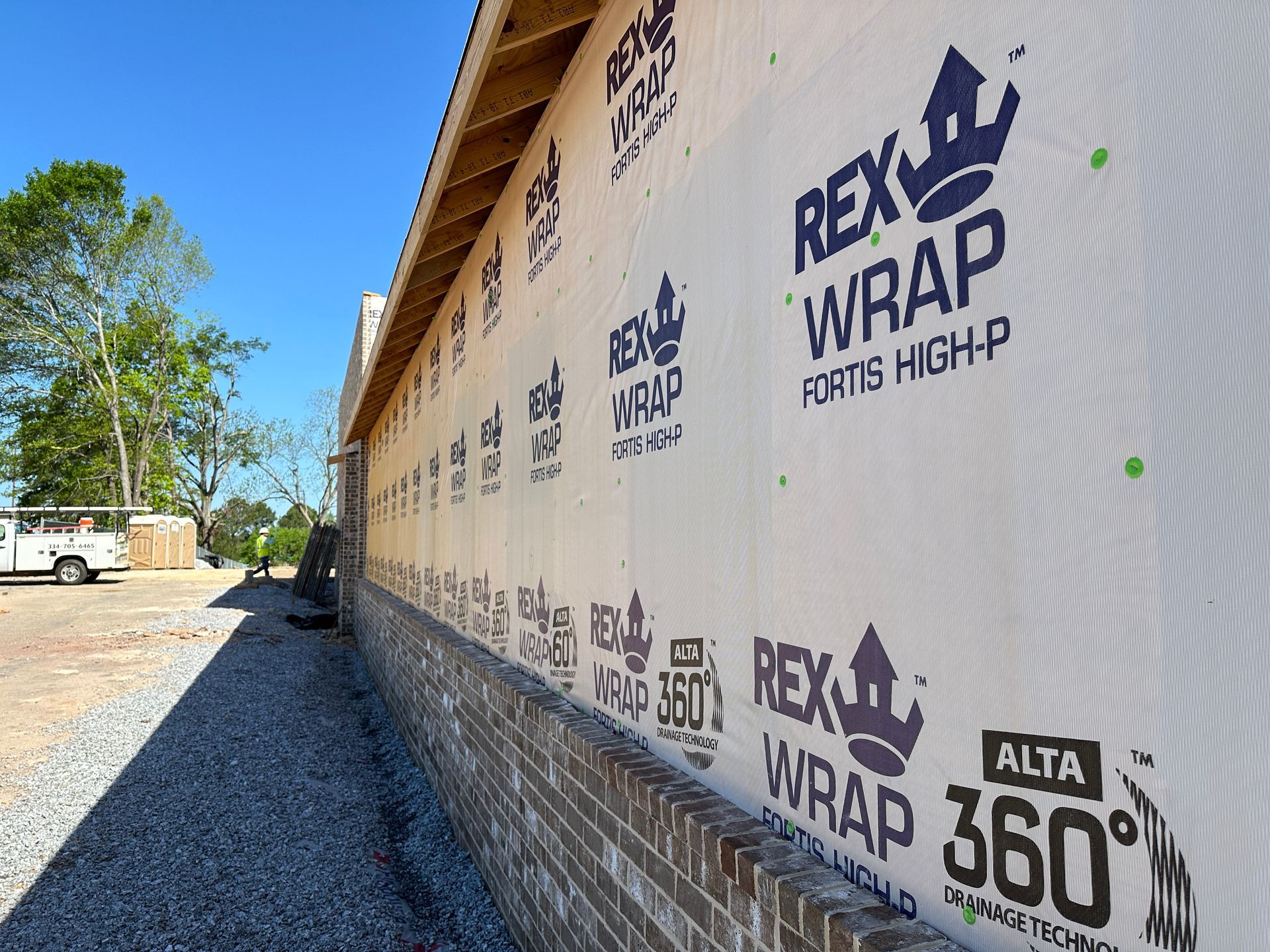 A brick wall with a lot of rex wrap on it