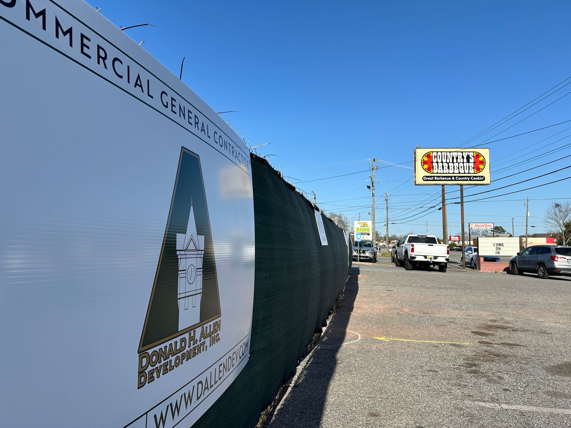 A fence with a sign on it that says commercial cemetery