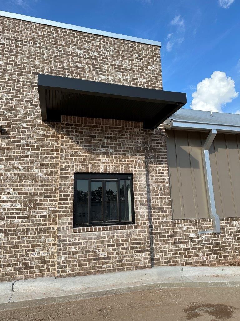 A brick building with a window and a canopy over it