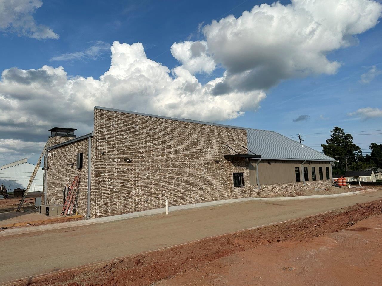 A large stone building with a cloudy sky in the background