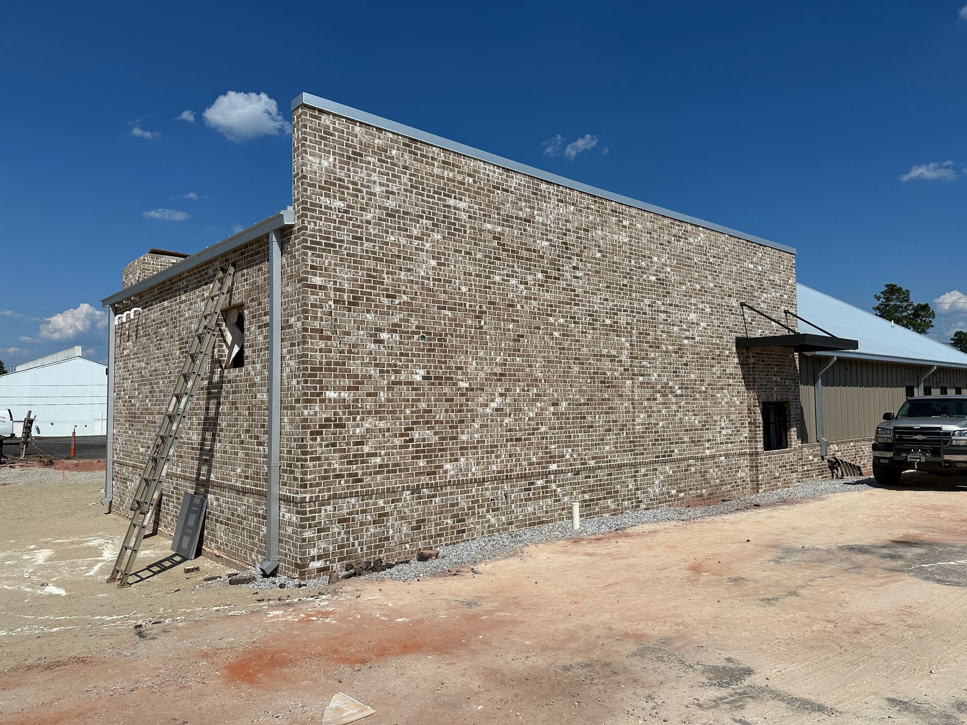 A brick building with a truck parked in front of it