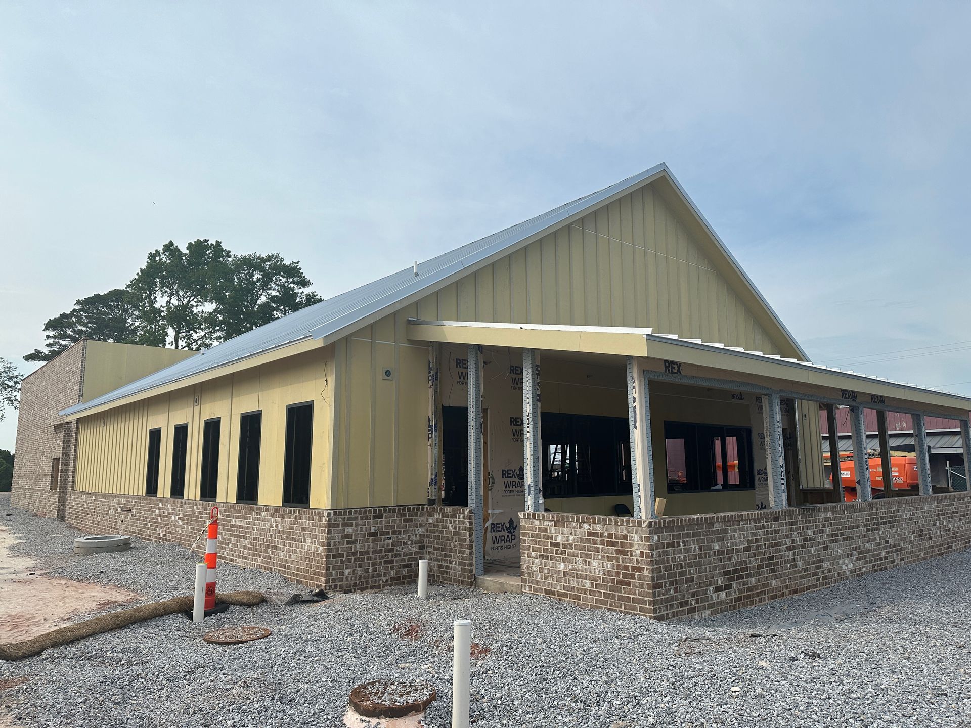 A large building with a porch is being built.