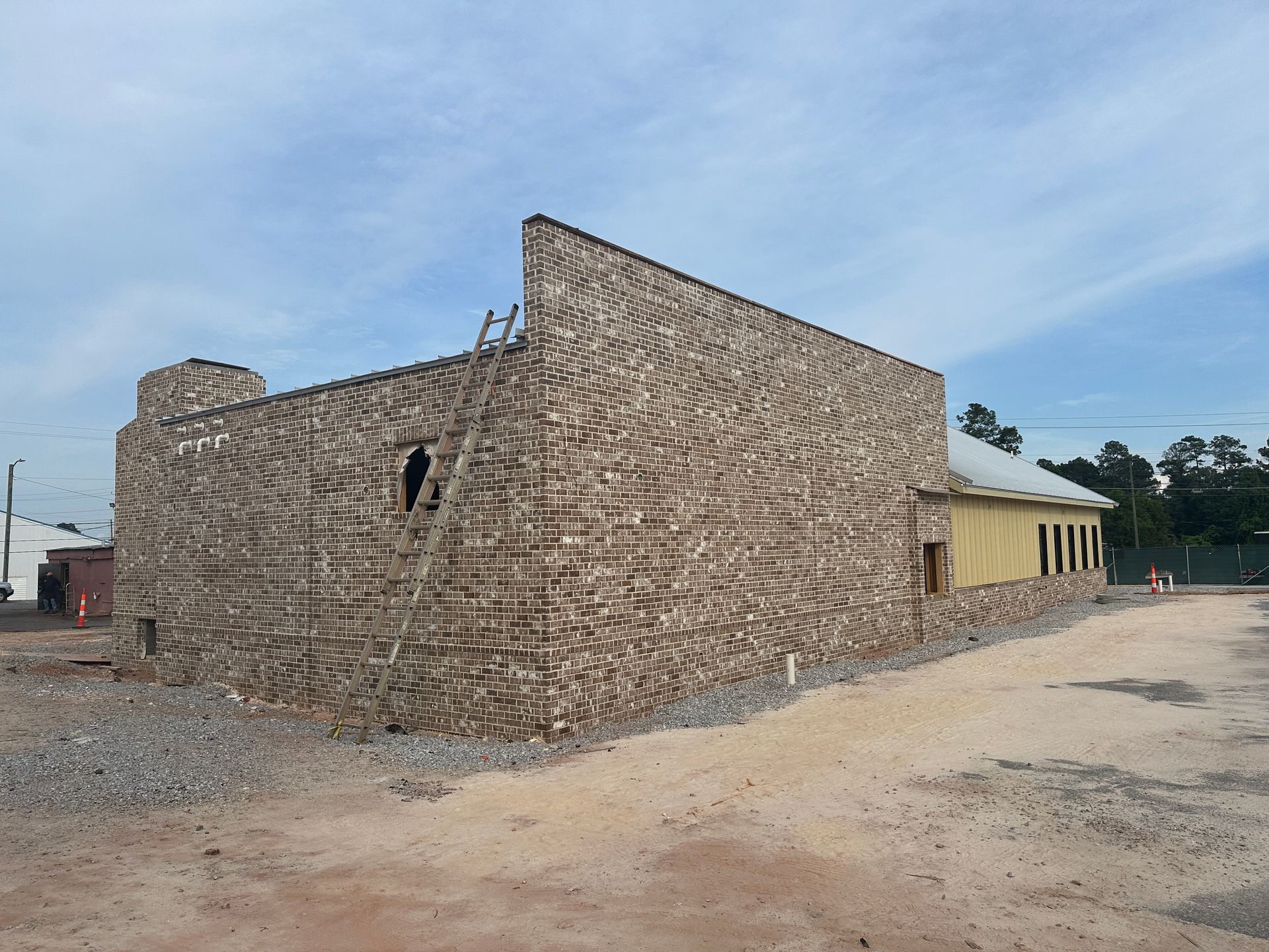 A large brick building with a ladder on the side of it