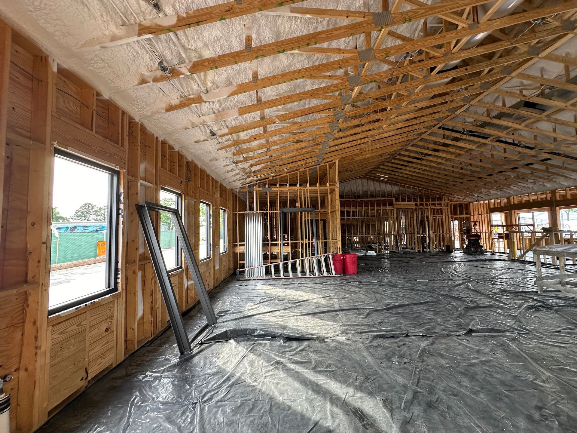 The inside of a building under construction with a lot of windows.