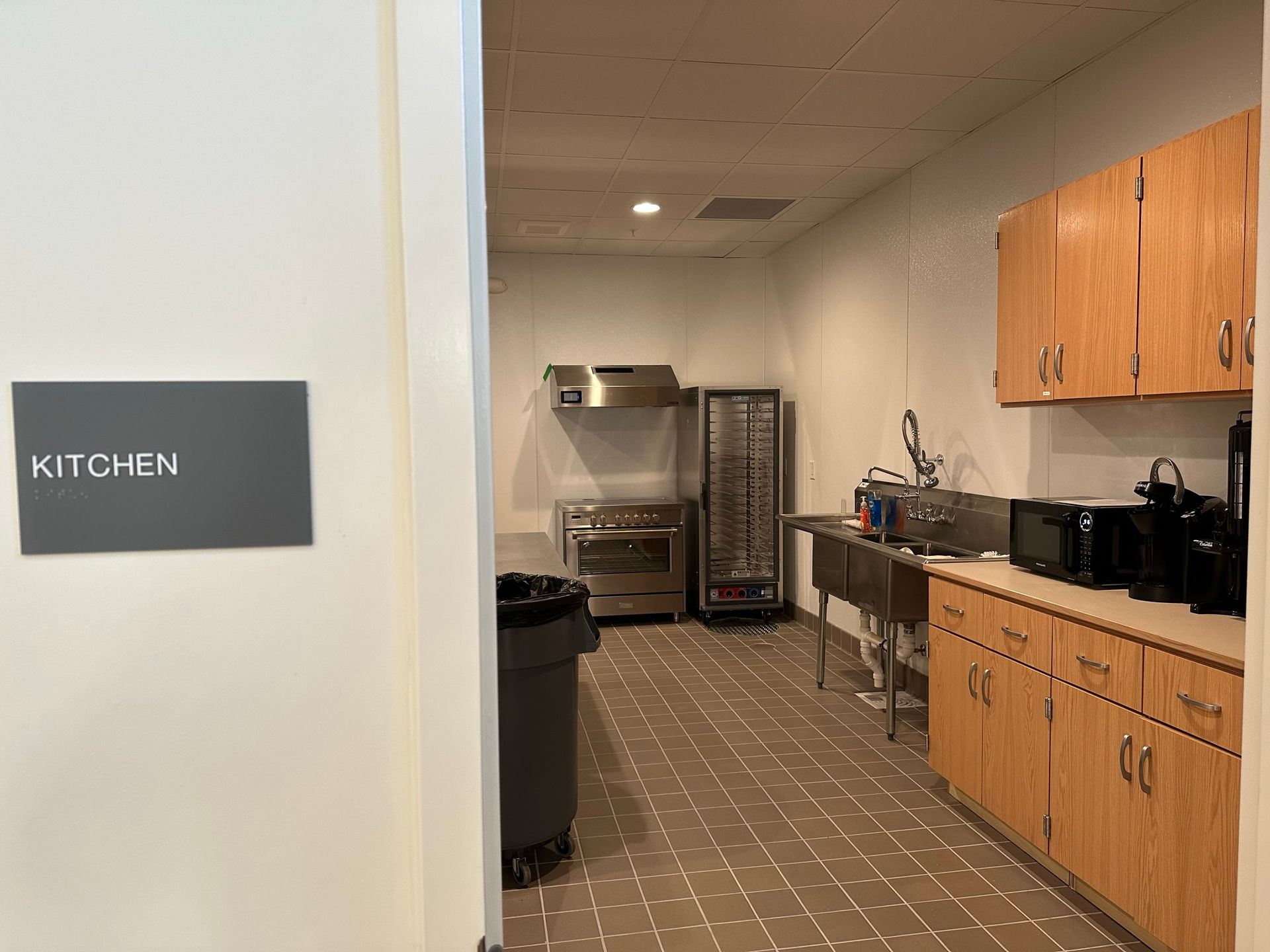 A kitchen with a sign that says kitchen on it.