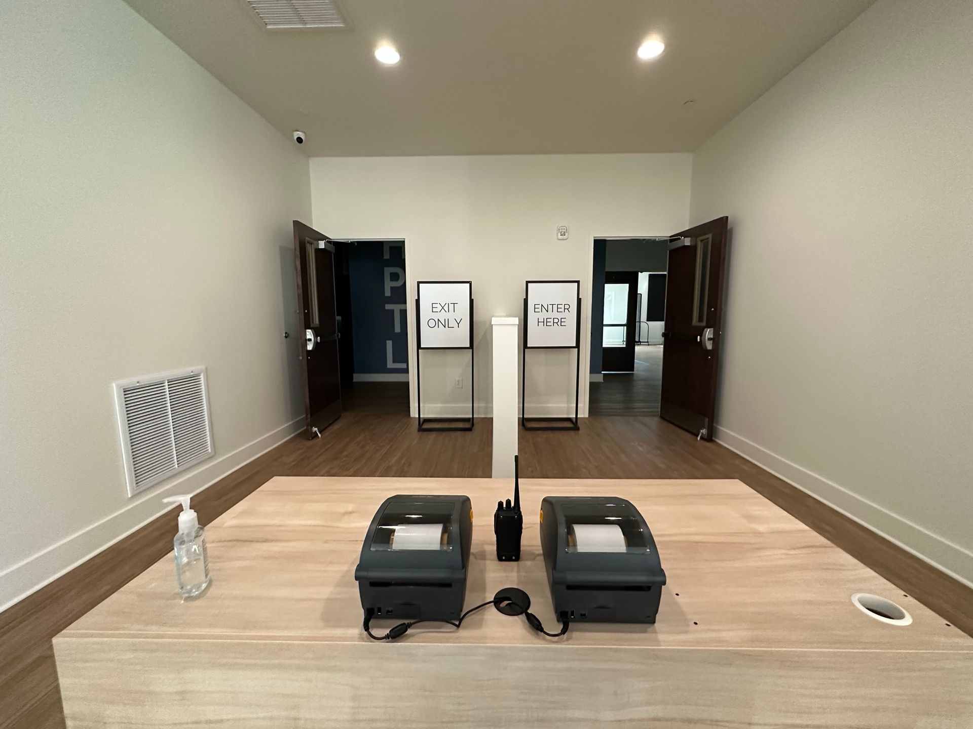 A room with a table and two printers on it