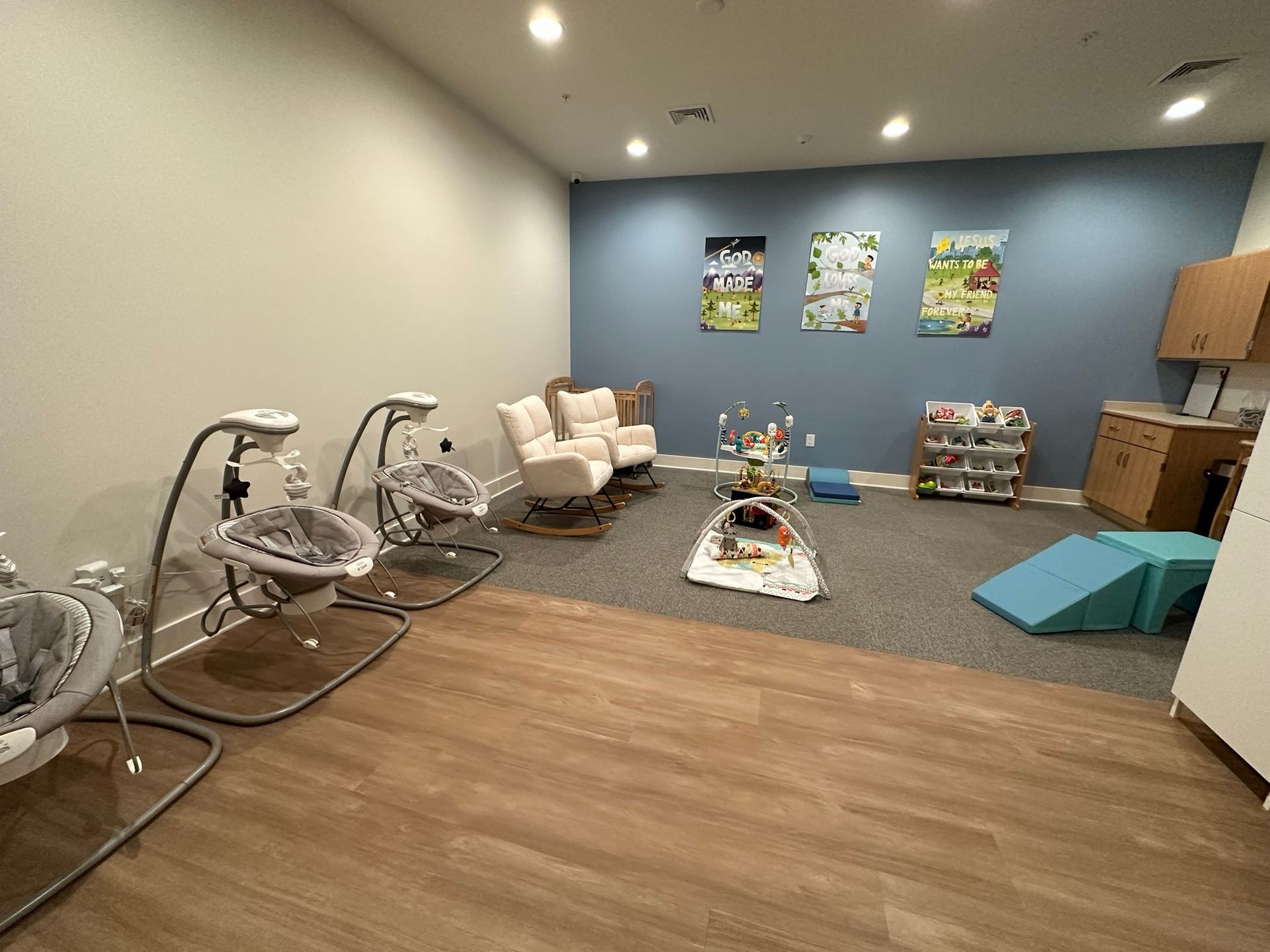 A room with a lot of toys and chairs in it.