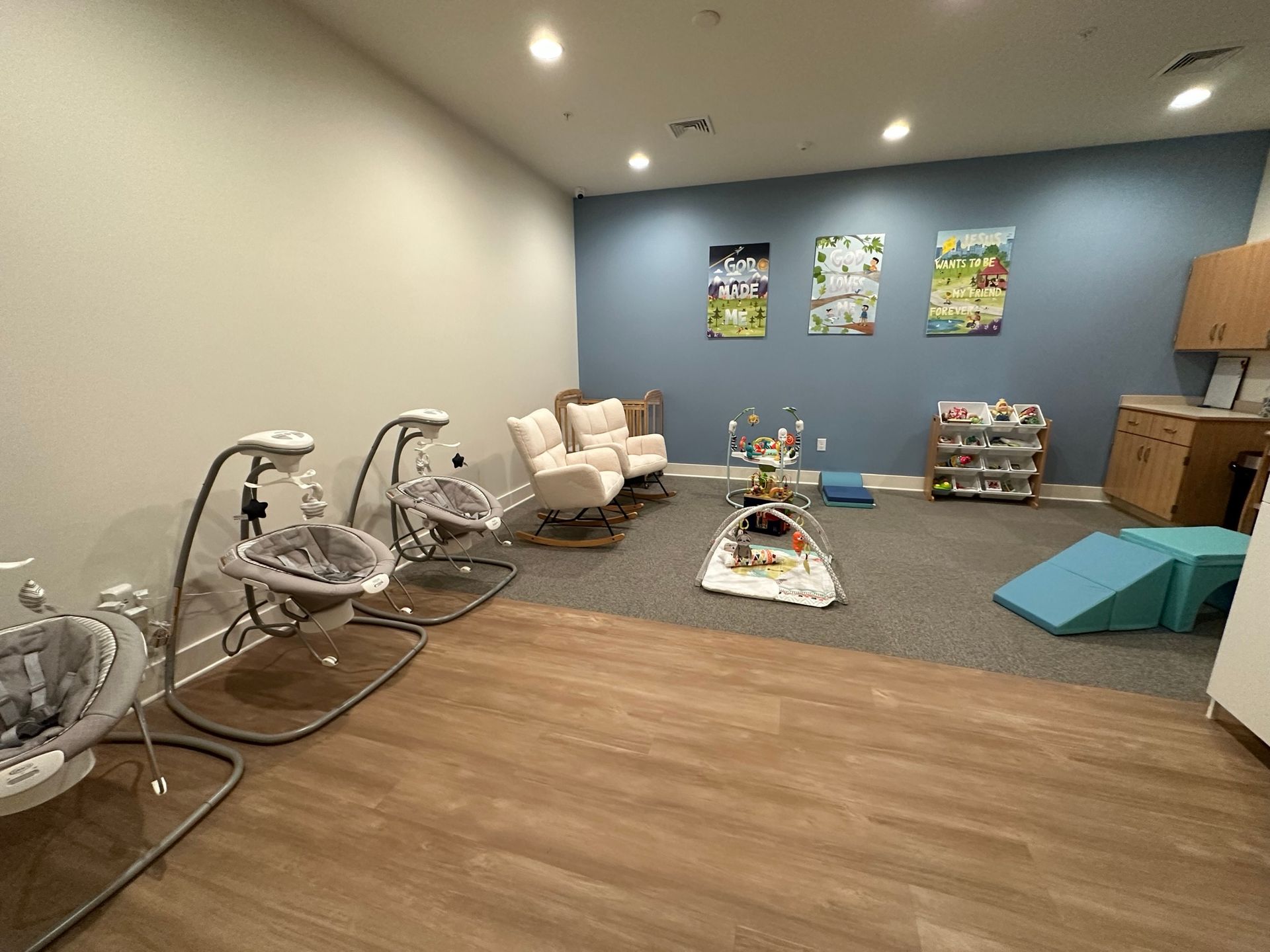 A room with a lot of baby swings and chairs in it.